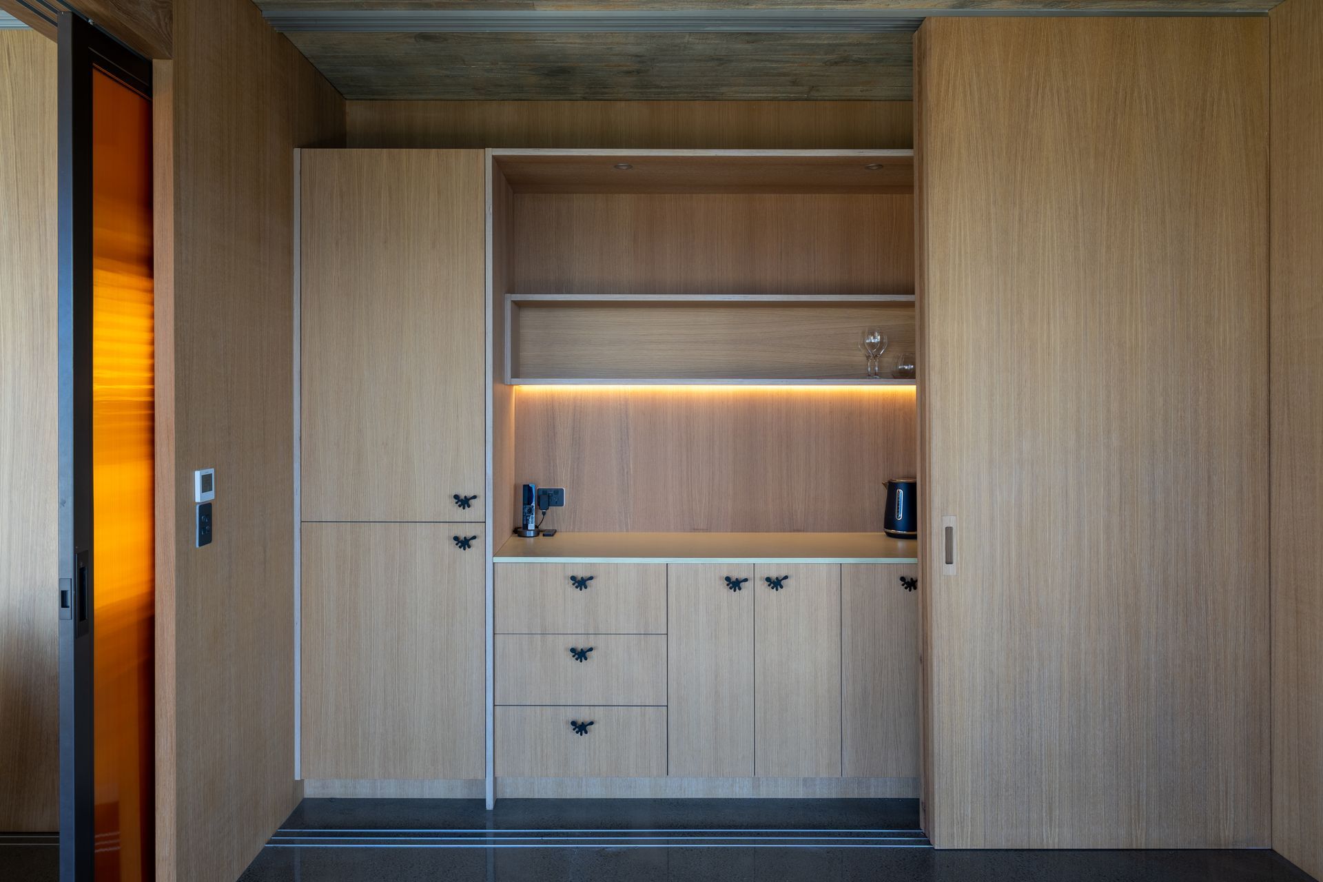 A kitchenette and storage have been incorporated into the downstairs multifunctional space.