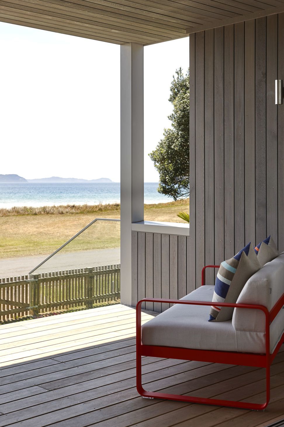 The front deck is furnished with a Jardin outdoor lounge, creating a comfortable place to relax while enjoying uninterrupted views across the ocean. The generous deck extends the home's living spaces into the landscape.