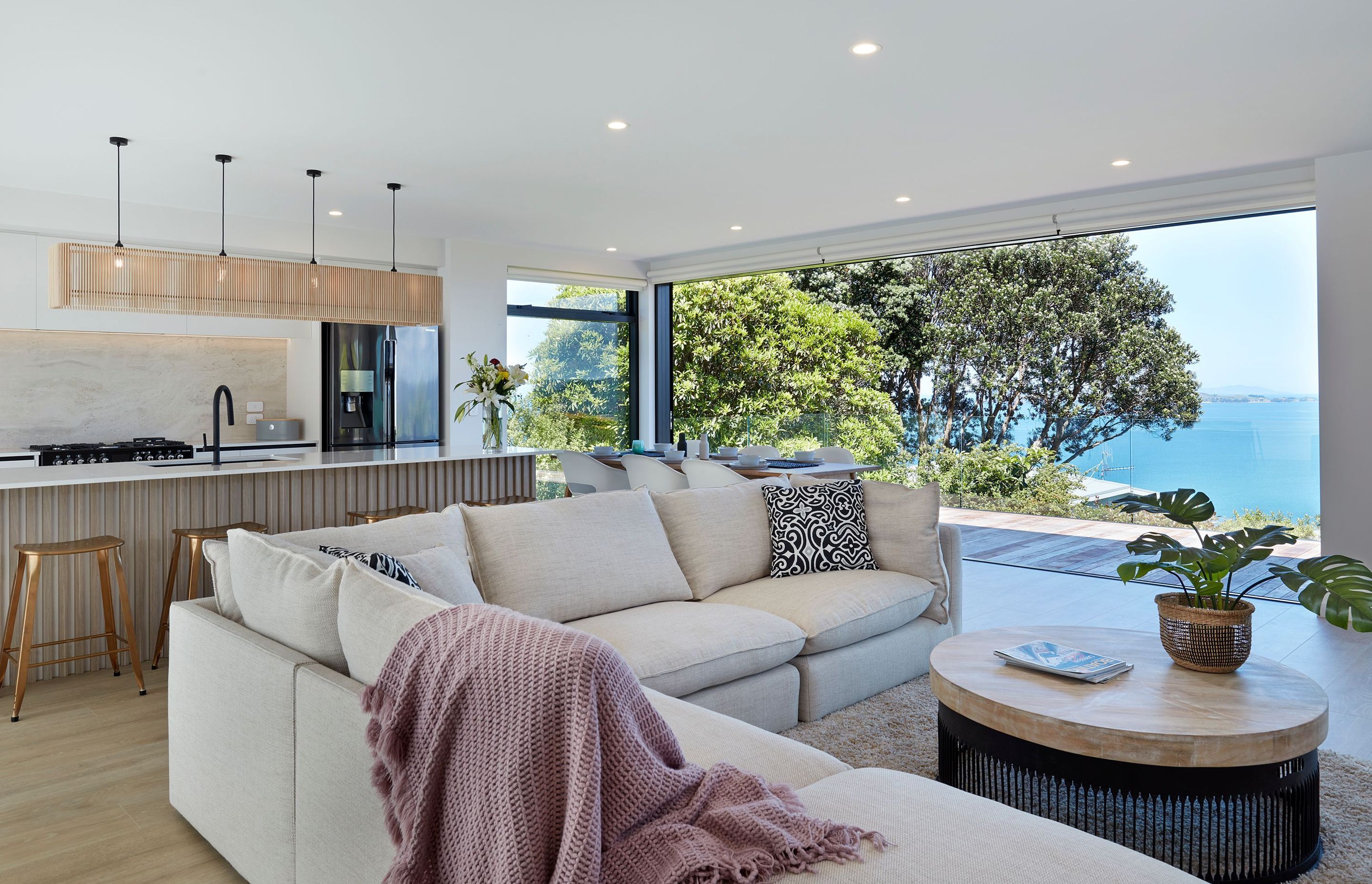 In the living room, where the double-glazed joinery from the APL Architectural and Metro series slides right back for full connection to the landscape, an L-shaped Sorrento sofa from Freedom wraps around a Jena coffee table from Republic Home.