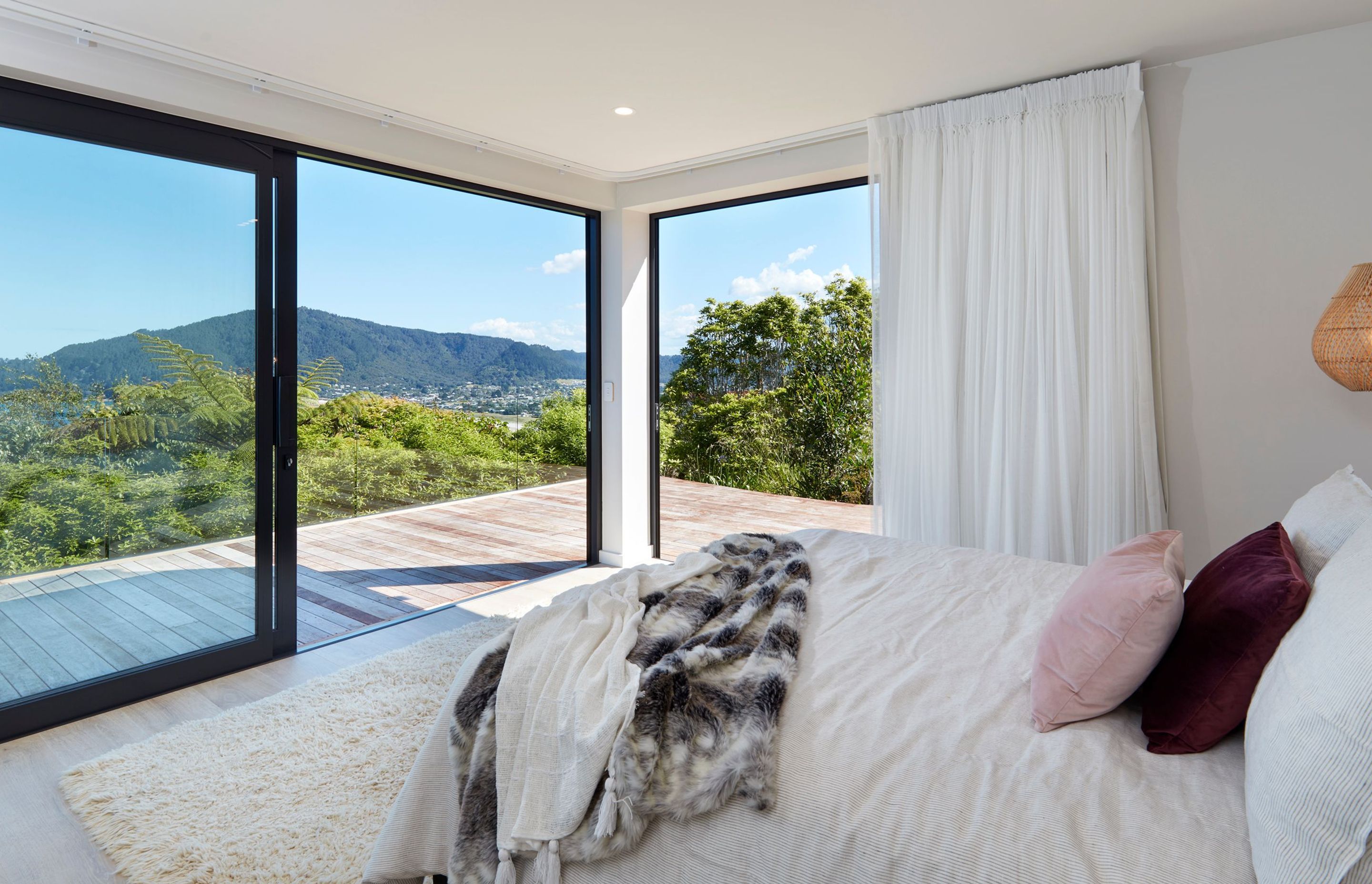 The main bedroom is positioned at the front of the home and the CurtainStudio team in Whitianga suggested the floaty white drapes to emphasise the holiday feel.