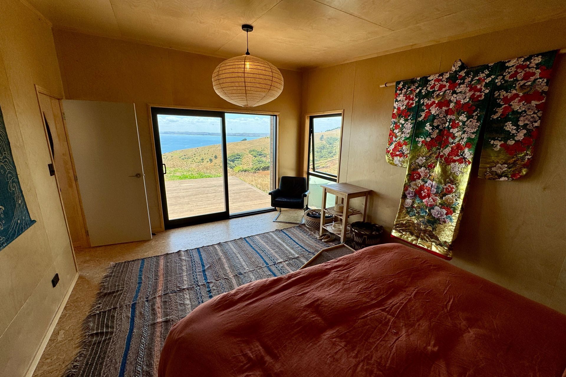 Master bedroom with birch walls and satin OSB flooring