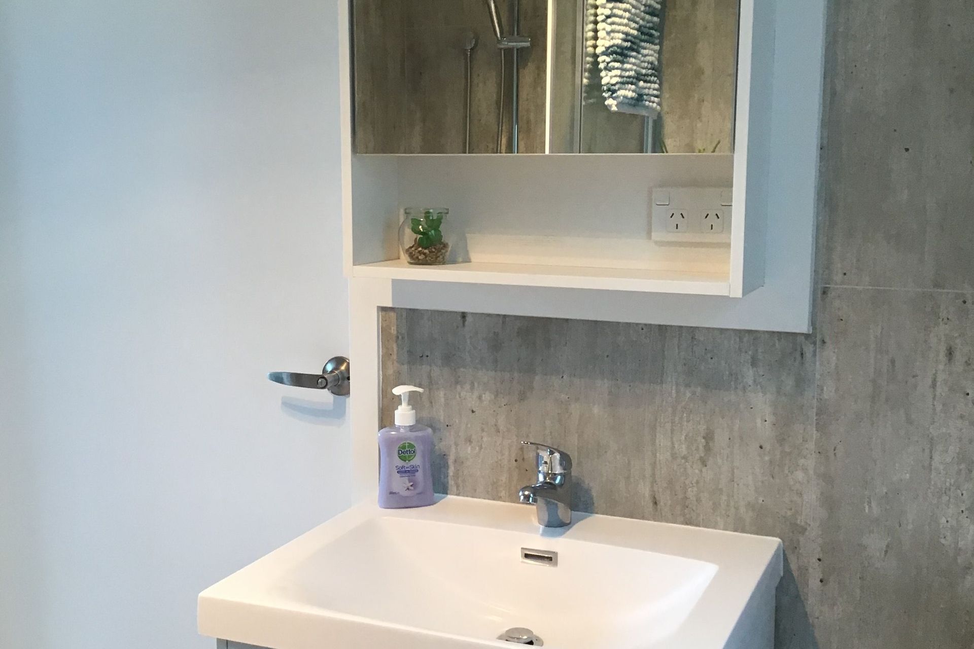 Vanity with mirror cabinet above for additional storage