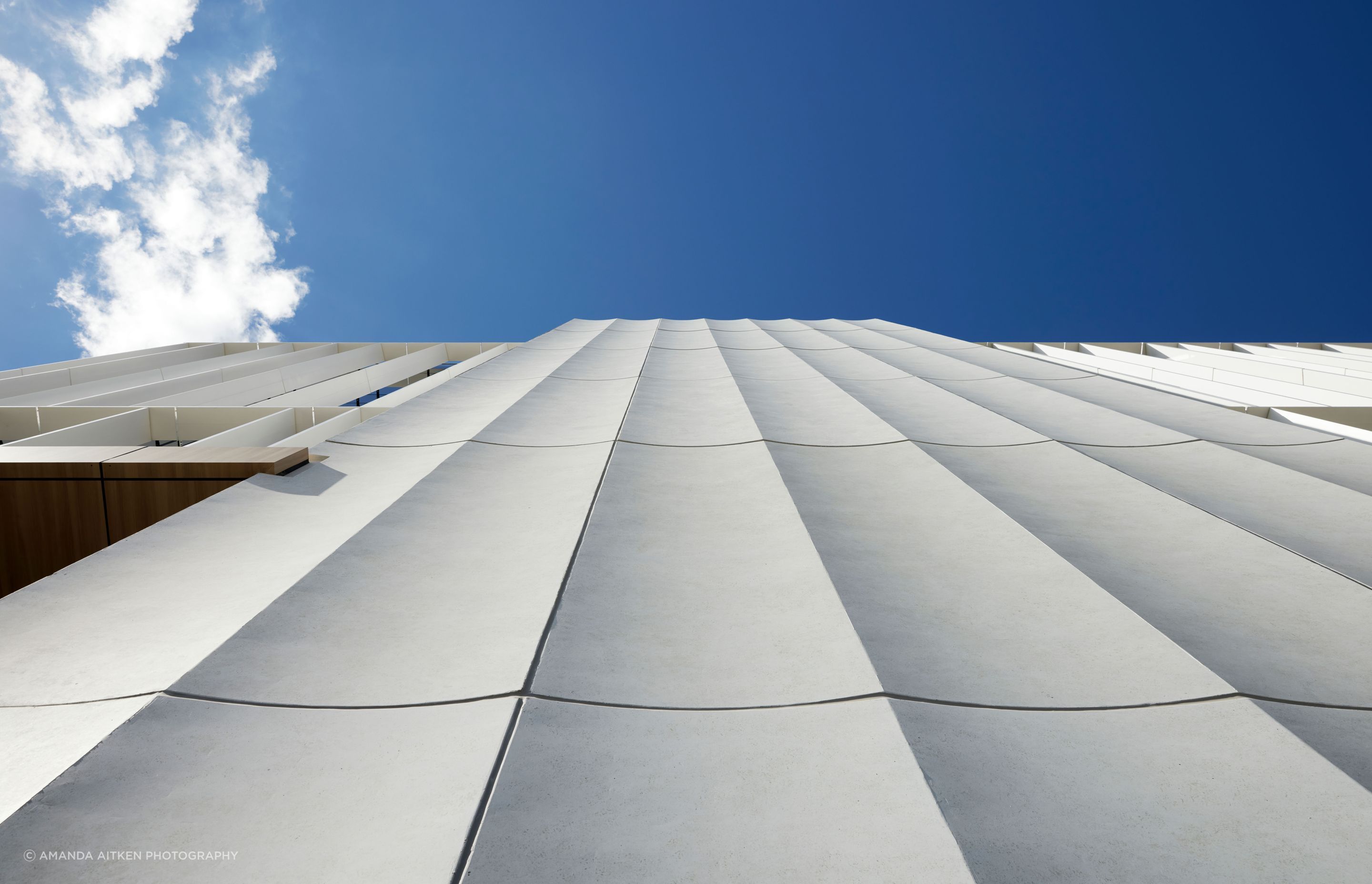 The fluted panels are precast concrete.