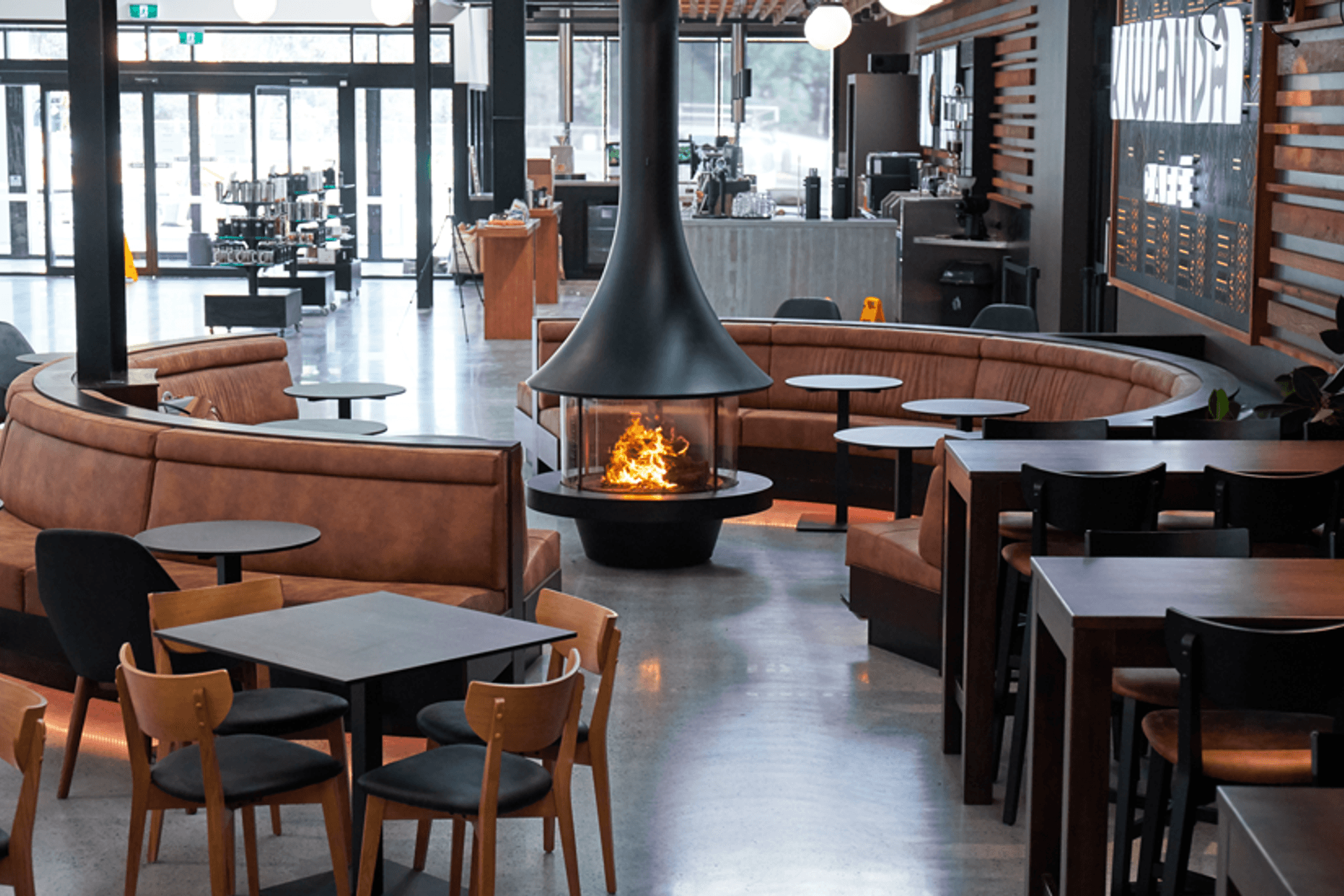 The JC Bordelet Eva 992 wood fireplace, providing a place for customers to enjoy an artisan coffee in a relaxed ambient environment