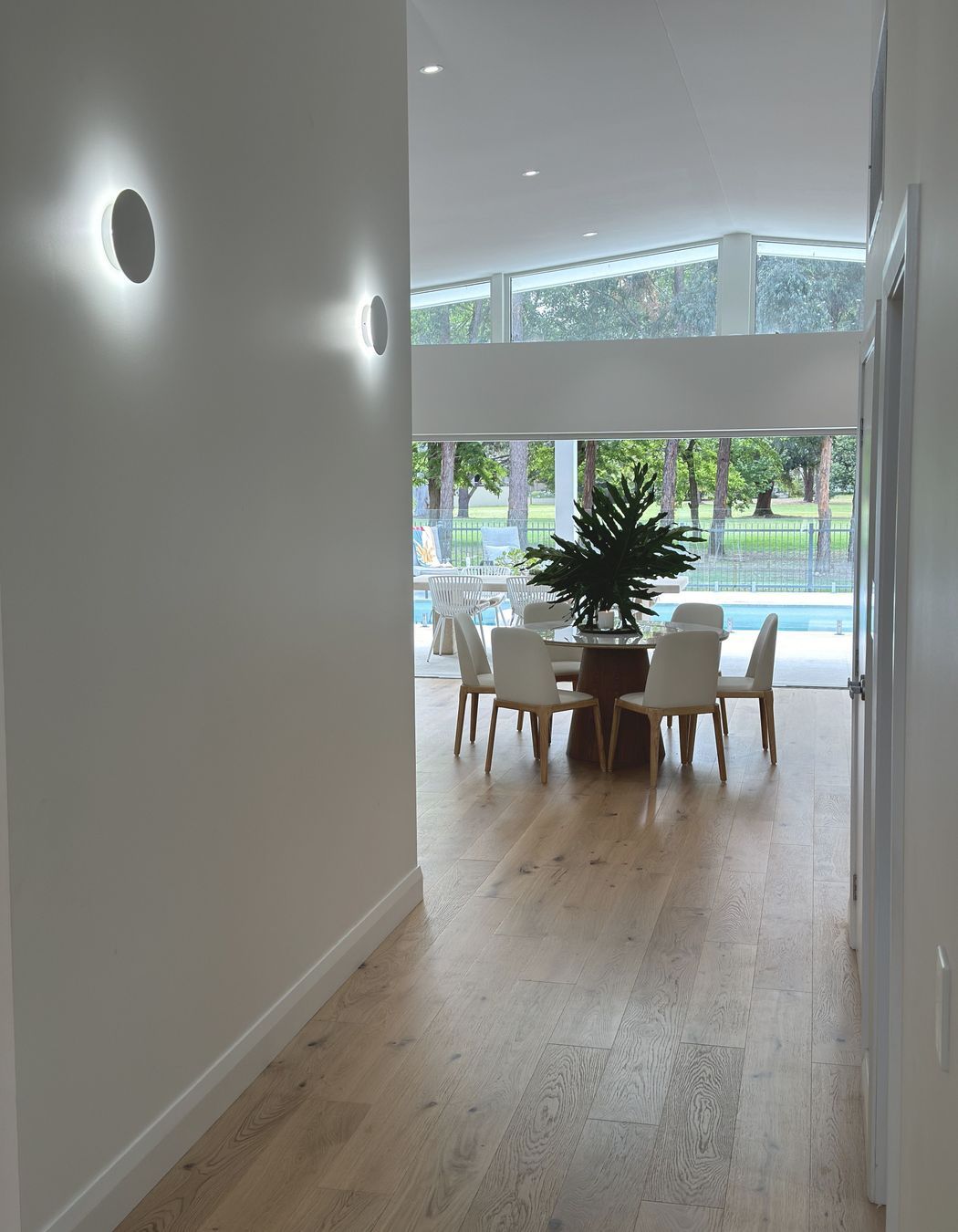 View through the dining room to the green foliage of the golf course.