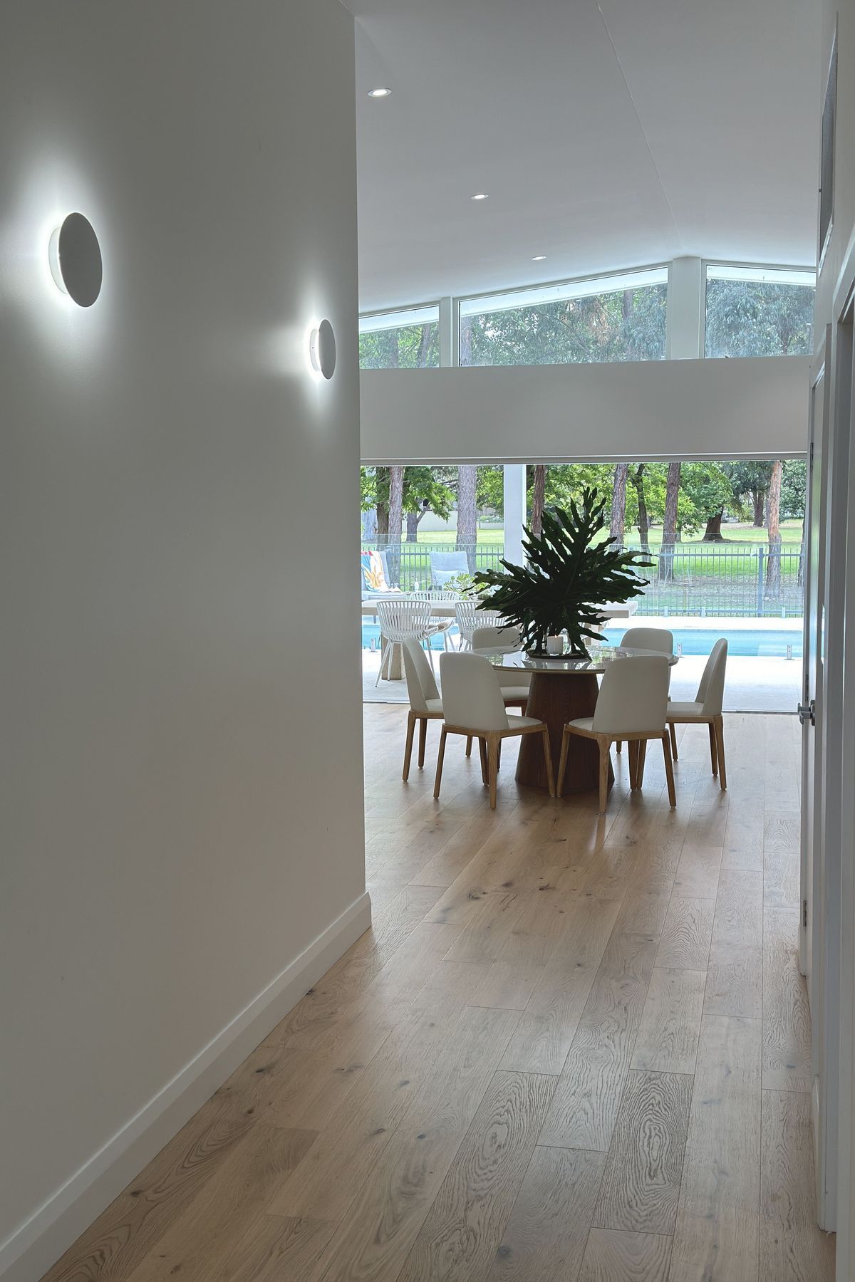 View through the dining room to the green foliage of the golf course.