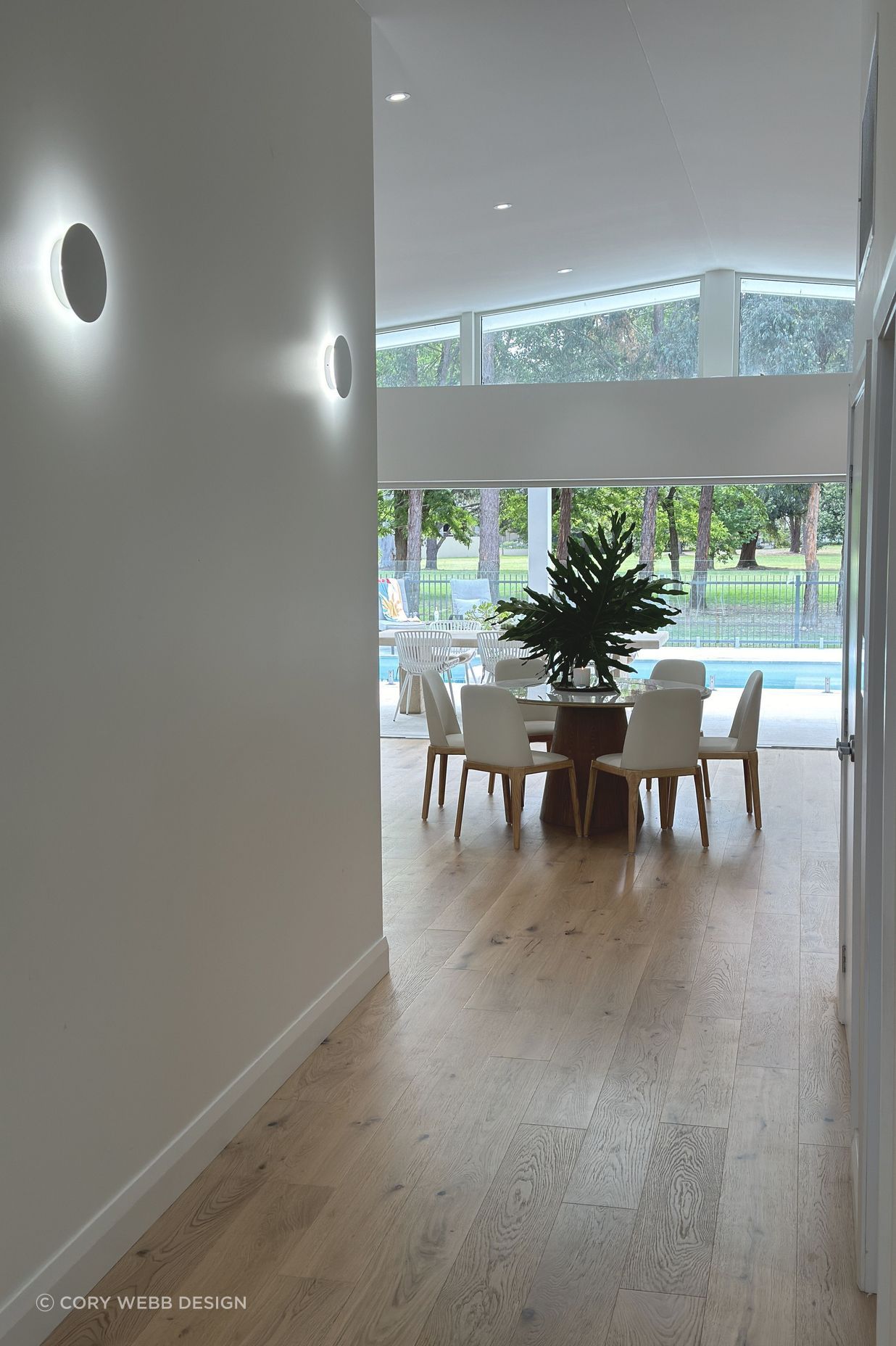 View through the dining room to the green foliage of the golf course.
