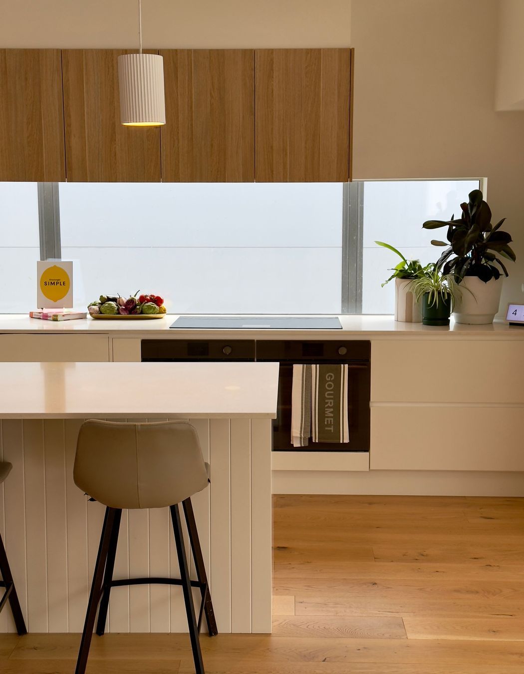 The quality of the light in the kitchen is enhanced by the splashback window