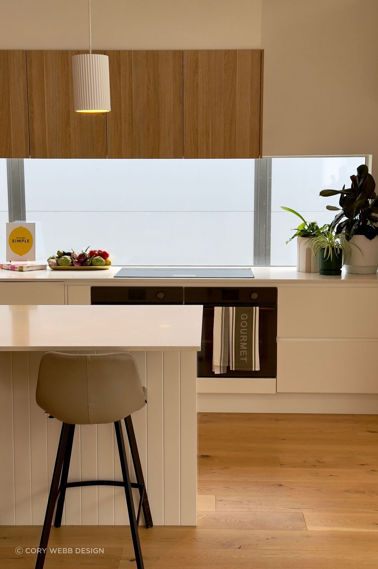 The quality of the light in the kitchen is enhanced by the splashback window