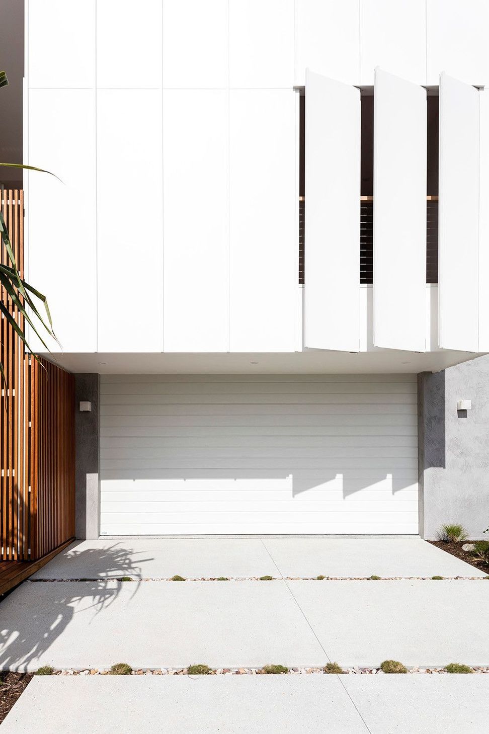 Viner Residence - Exterior. White brick facade with vertical fins above the garage.