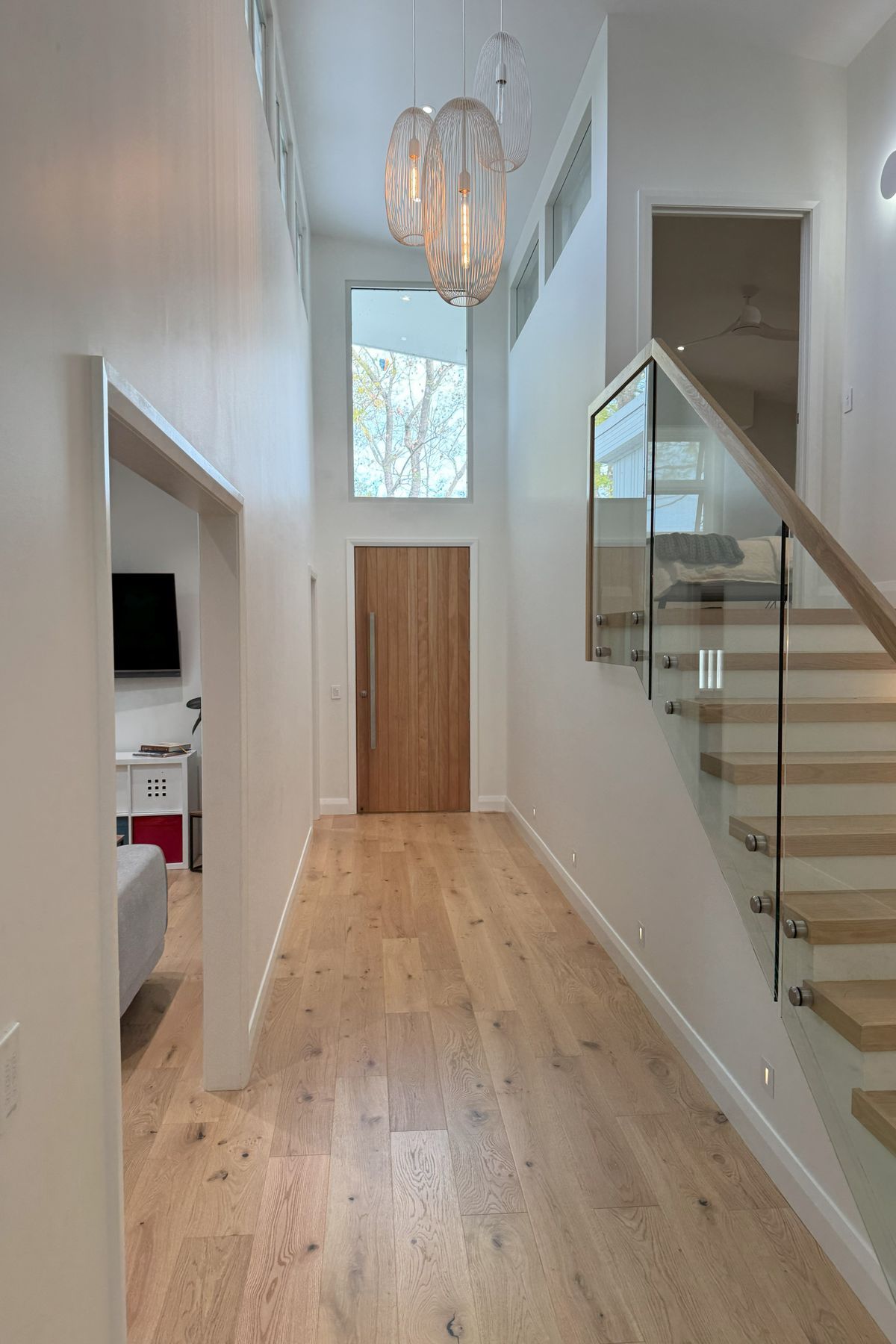 Double height entry flooded with natural light, spilling into the parents bedroom upstairs and into the kids rumpus room.
