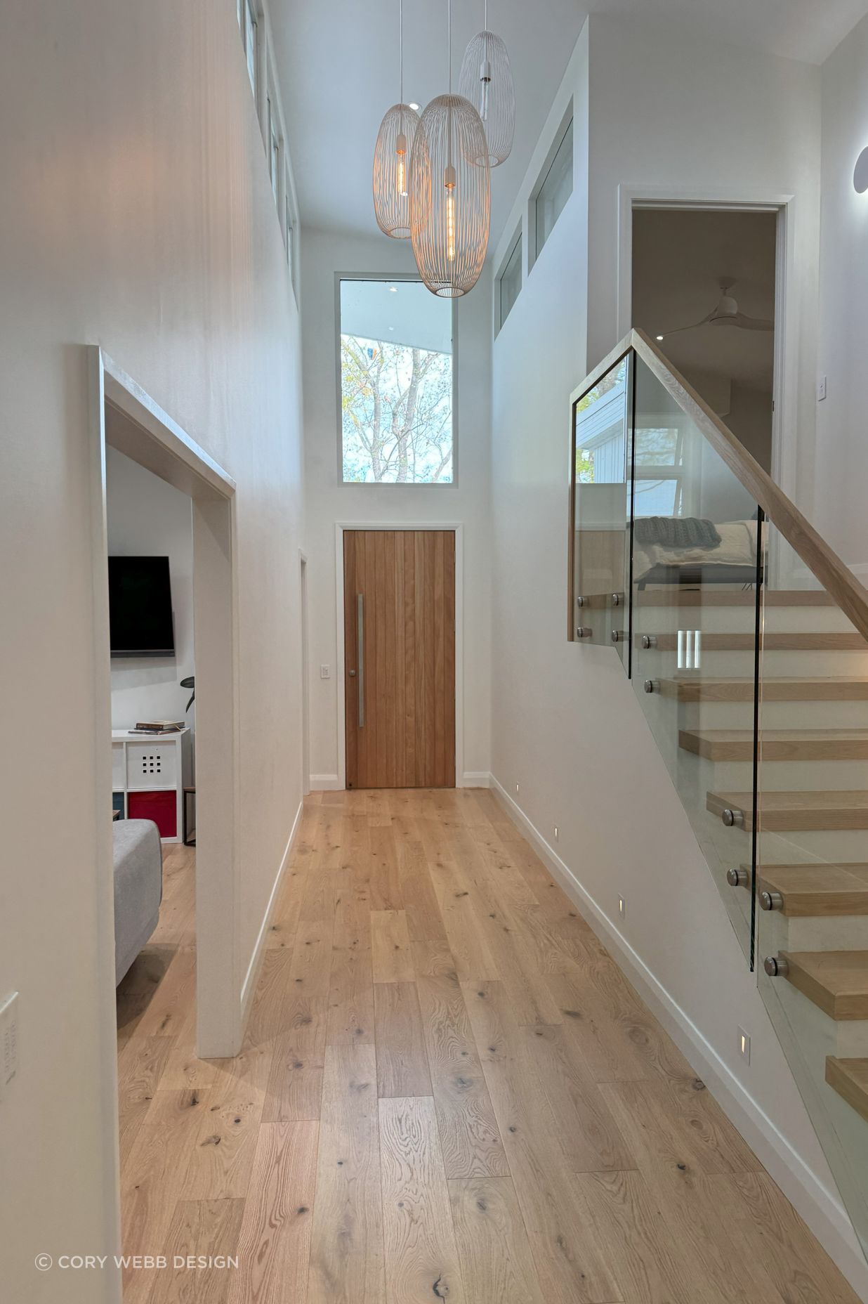 Double height entry flooded with natural light, spilling into the parents bedroom upstairs and into the kids rumpus room.