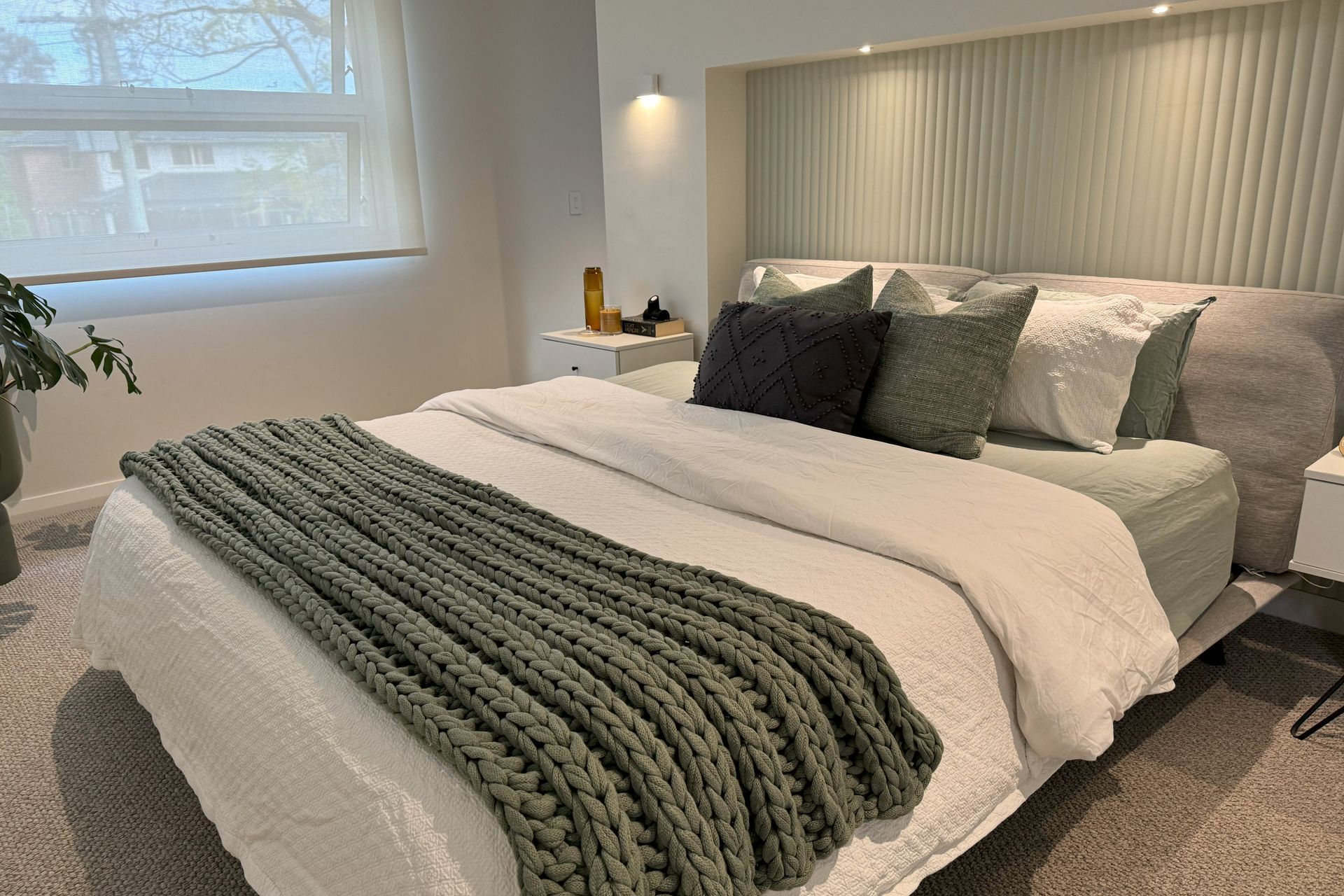 The main bedroom has a custom inbuilt bedhead with independent lighting controls