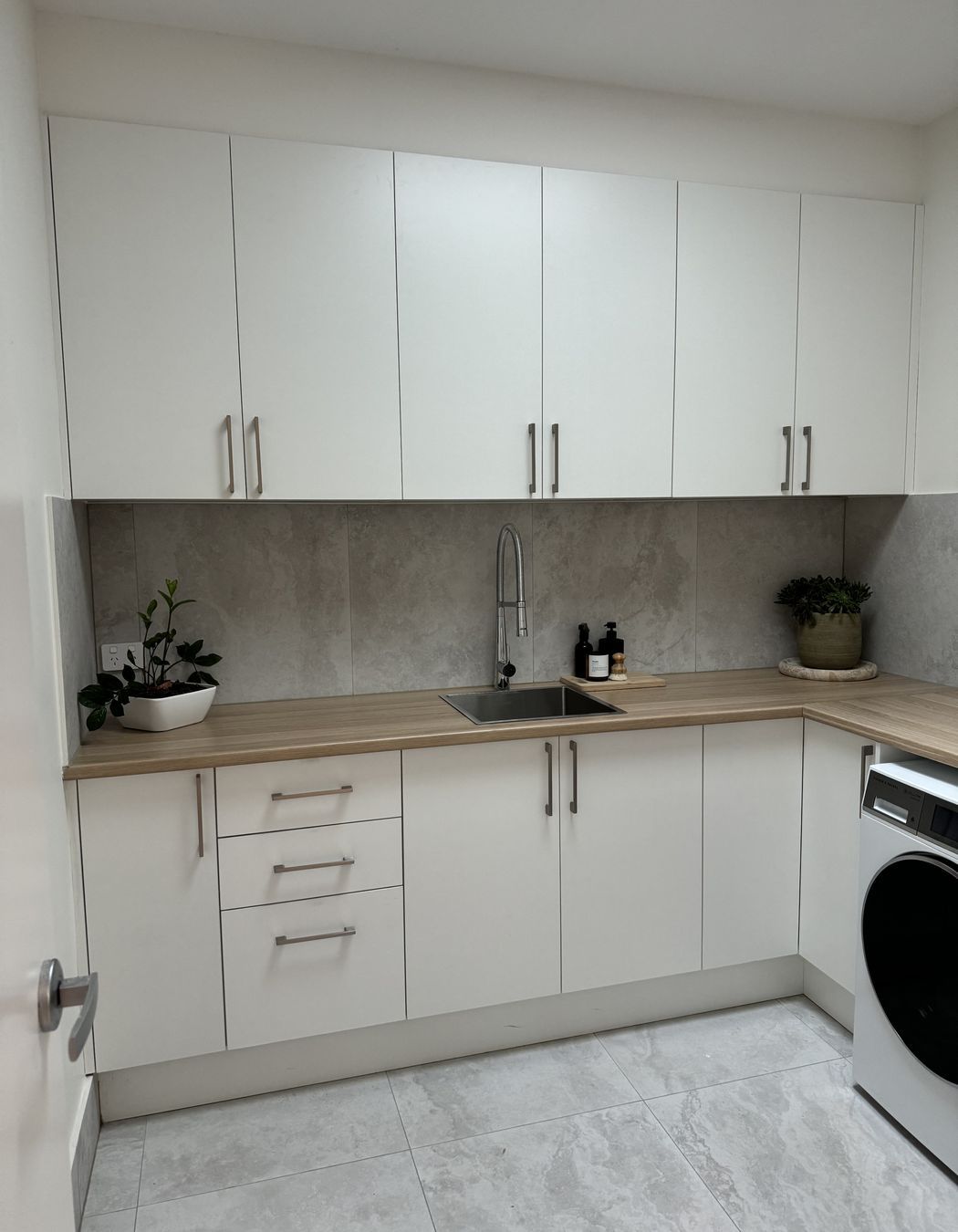 The laundry has abundant natural light from a sensored skylight