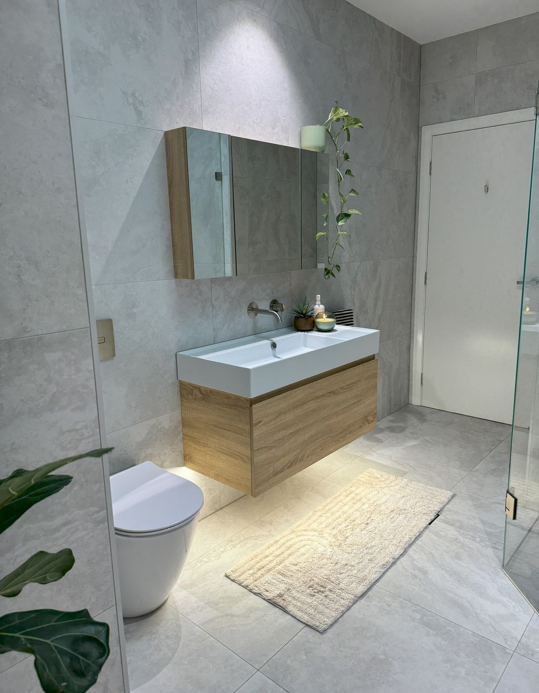 The warmth of the bathroom comes from the timber features and skylight