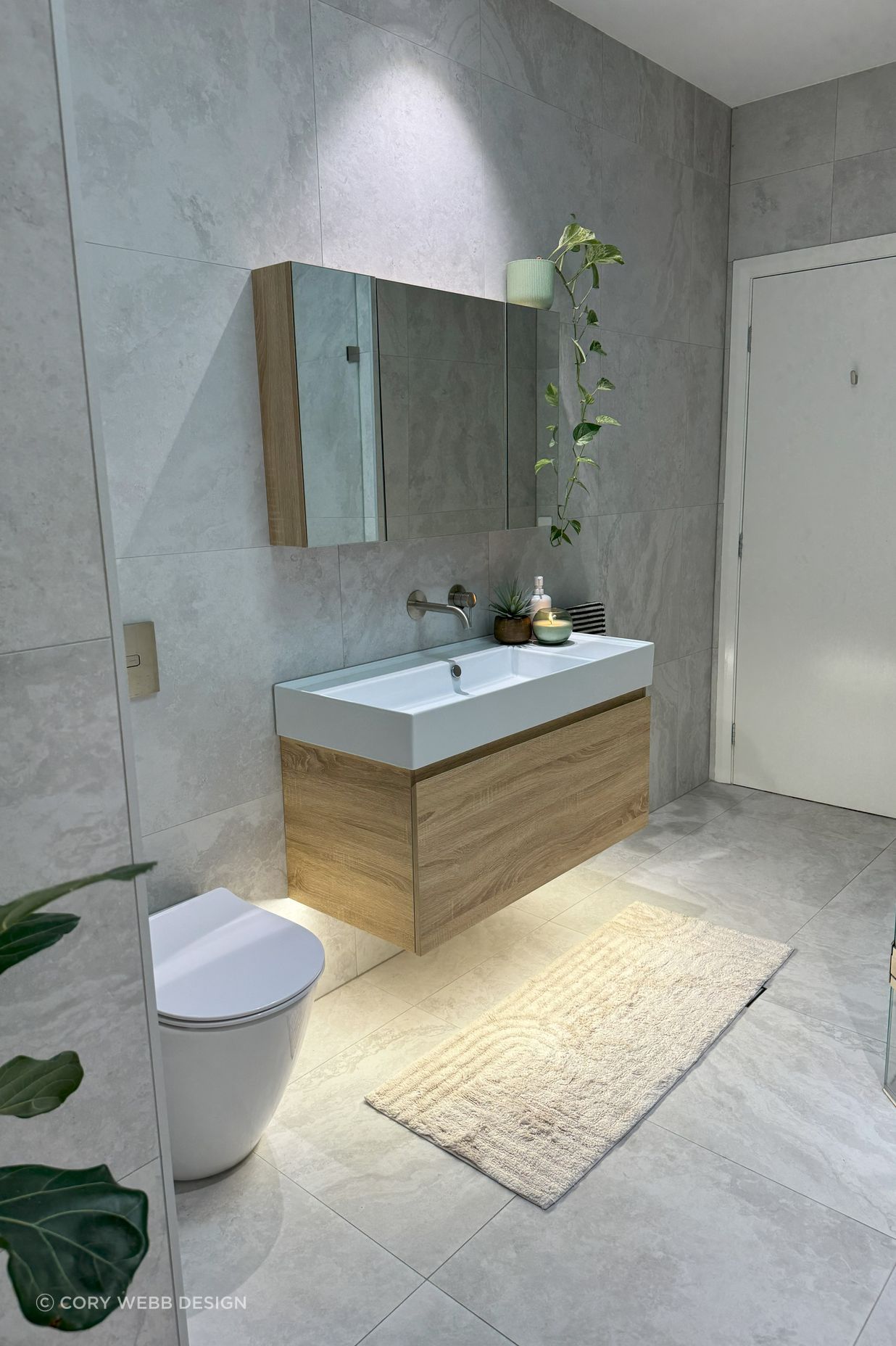 The warmth of the bathroom comes from the timber features and skylight