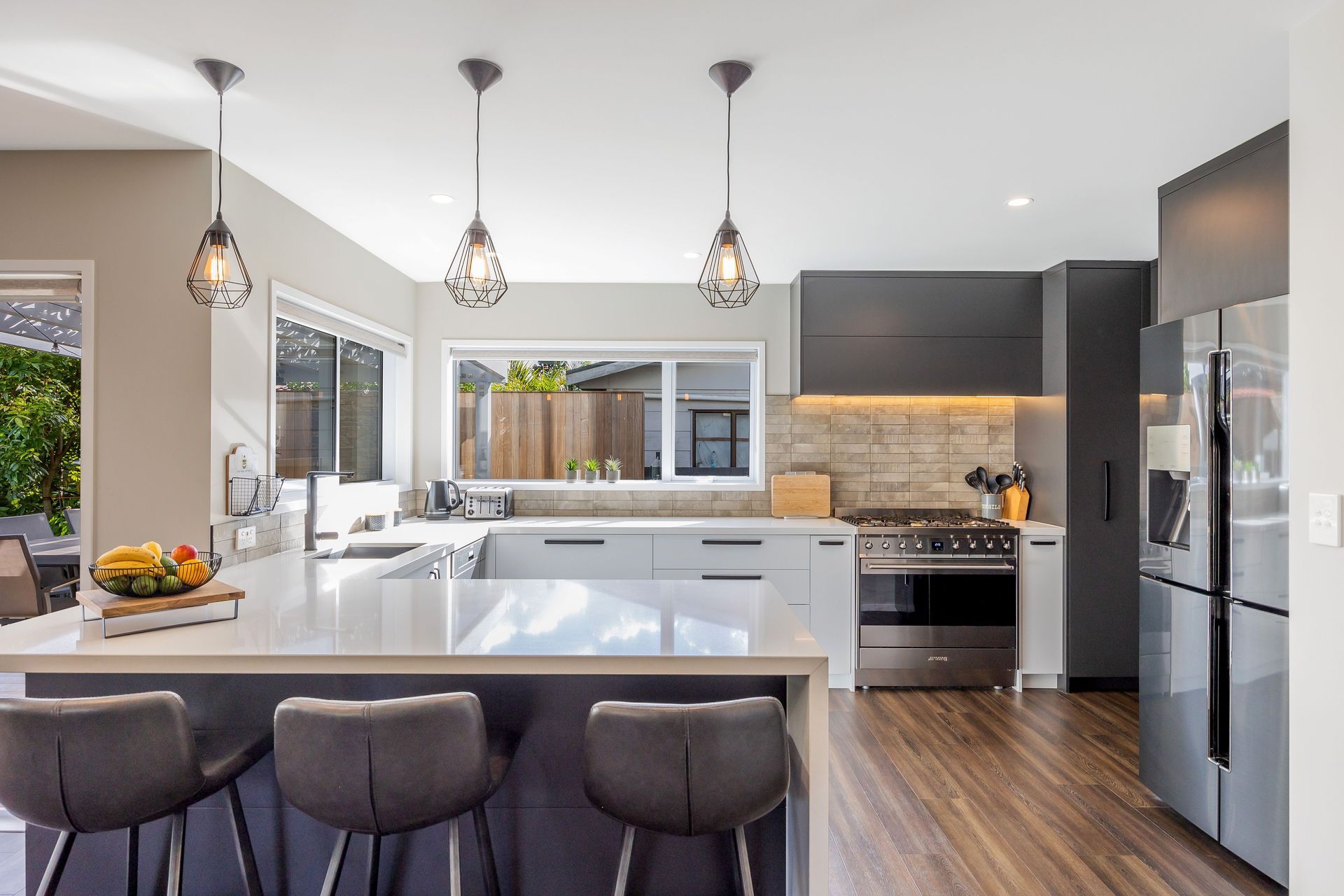 Designing a home that caters to the needs of the entire family is so important, as it fosters harmony, encourages bonding, and creates a welcoming sanctuary where each member, including pets, feels valued and content. Designing for families involves creating spaces that facilitate togetherness and encourage shared activities. Open floor plans that seamlessly connect living areas, dining spaces, and kitchens promote interaction among family members. A home should not only be aesthetically pleasing, but it should also be comfortable, family-friendly, and pet-friendly.  This home truly reflects the people and pets who reside within it. Each space has carefully chosen artwork and furniture pieces to enhance the living experience. The indoor-outdoor flow maximizes the penetration of natural light into the home. The glazed areas not only brighten the interior but also create a sense of openness and spaciousness. The extended deck becomes an extension of the interior, providing additional areas for relaxation, entertaining guests, or engaging in various activities. Being able to easily access and enjoy outdoor spaces promotes a sense of tranquility, relaxation, and well-being. It also encourages outdoor activities, such as outdoor dining, or simply unwinding in nature, fostering a healthier and more balanced lifestyle.