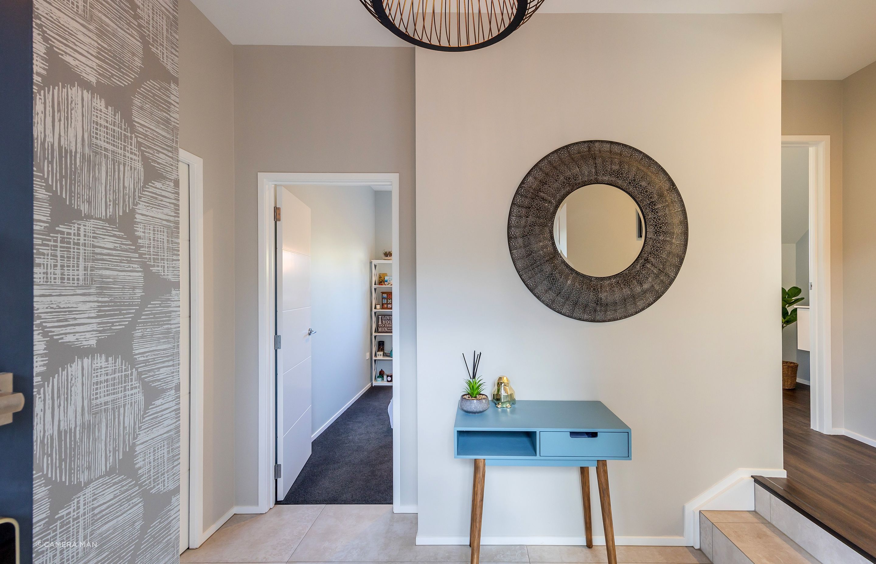 The entry foyer sets the tone for the rest of the home. It creates an initial impression and establishes the overall ambiance and style. We included an in-built closet to ensure that the space can remain cutter free, providing a designated space for belongings. We wanted to create a visual impact, by using a feature wallpaper and feature pendant light. The client found the mirror, which really sets the aesthetic tone for the rest of the interior. Aspiring Walls Focus Collection Spots & Stripes Page 33 Pattern 30550-1 to feature wall Resene Alabaster to architraves & skirting Resene Triple White Pointer to all walls and ceiling Gravity Pearl Porcelain Tile 600x1200 Matt to entry floor with grout colour Mapei Medium Grey 112 (Tile layout: straight stack)