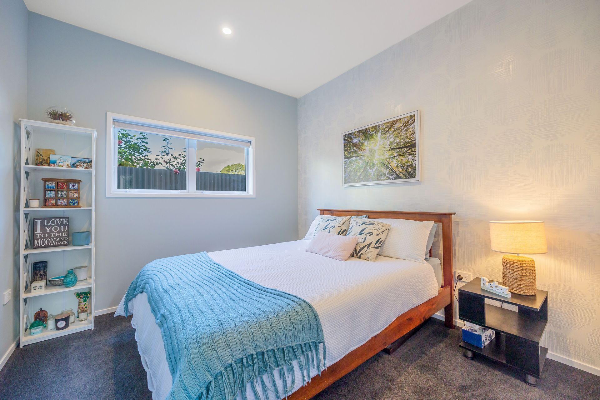 The Guest Bedroom has an inviting atmosphere. We used a colour scheme that complements the rest of the home, but provides a point of difference. We paid attention to textural influences by using wallpaper and allowing the space to be neutral enough for accessorising with bold colours and artwork. Resene Alabaster to ceiling, architraves &amp; skirting; Resene Half Emerge to all walls apart from feature wall; Aspiring Walls Focus Collection Spots &amp; Stripes Pattern No 30549-1 to feature wall; Feltex Okiwi Bay 020335 Coal Mine 0780 to floor
