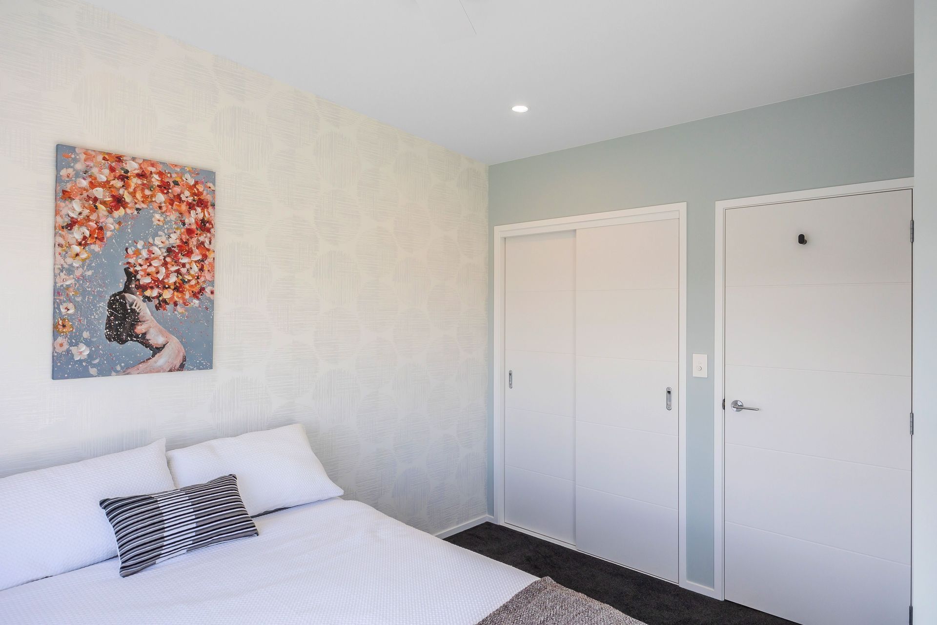 The Teenage Gir's Bedroom has an inviting, but sophisticated atmosphere. We used soft and soothing hues for a calming atmosphere. We created a focal point using wallpaper and adding artwork for a splash of colour. Resene Alabaster to ceiling, architraves &amp; skirting; Resene Half Emerge to all walls apart from feature wall; Aspiring Walls Focus Collection Spots &amp; Stripes Pattern No 30549-1 to feature wall; Feltex Okiwi Bay 020335 Coal Mine 0780 to floor