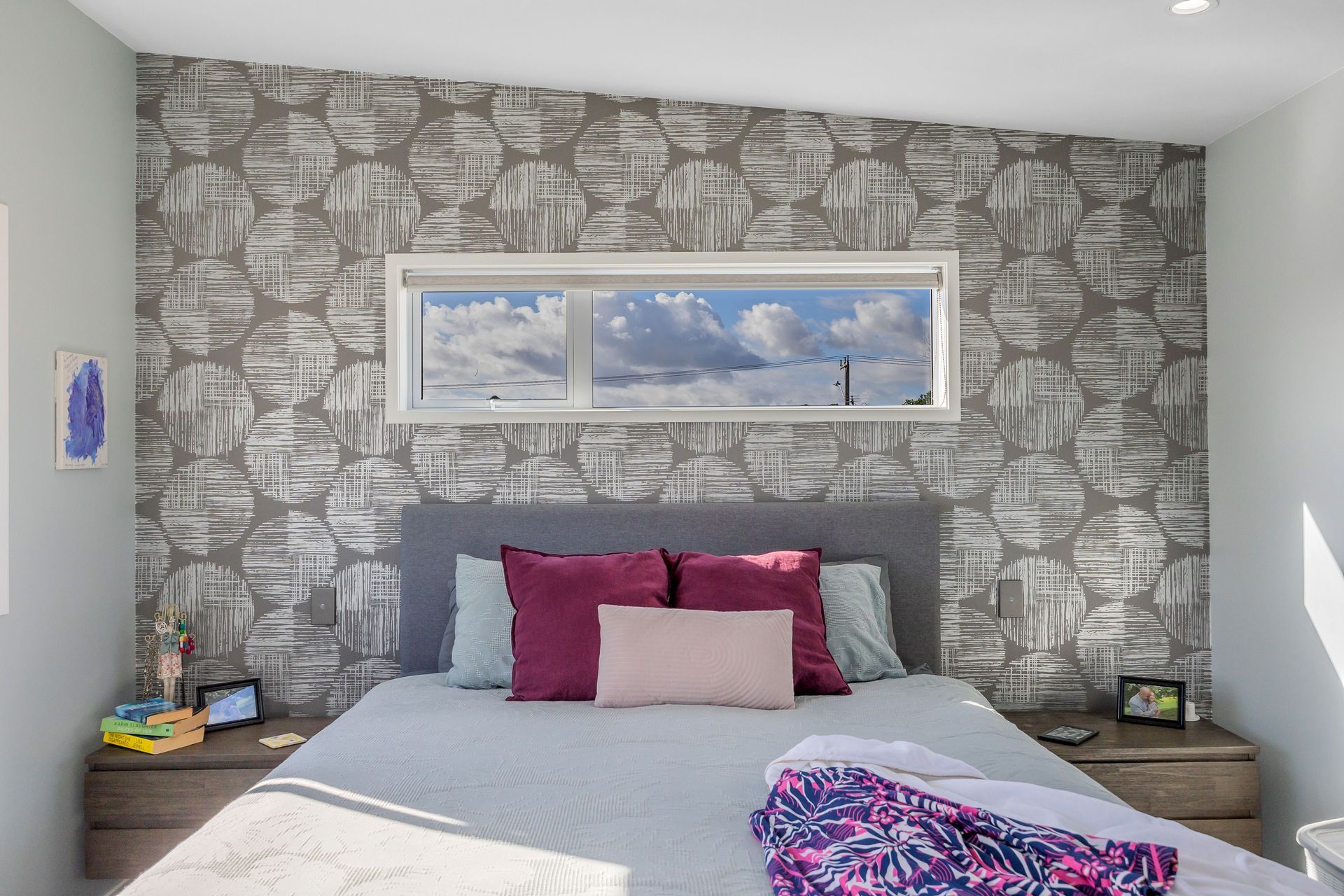 For the master bedroom we choose a color scheme that promotes a calm and relaxing atmosphere. Soft and neutral tones were used and we used the wallpaper to create depth and a focal point.  Resene Alabaster to ceiling, architraves &amp; skirting; Resene Half Emerge to all walls apart from feature wall; Aspiring Walls Focus Collection Spots &amp; Stripes Pattern No 30550-1 to feature wall; Feltex Okiwi Bay 020335 Coal Mine 0780 to floor