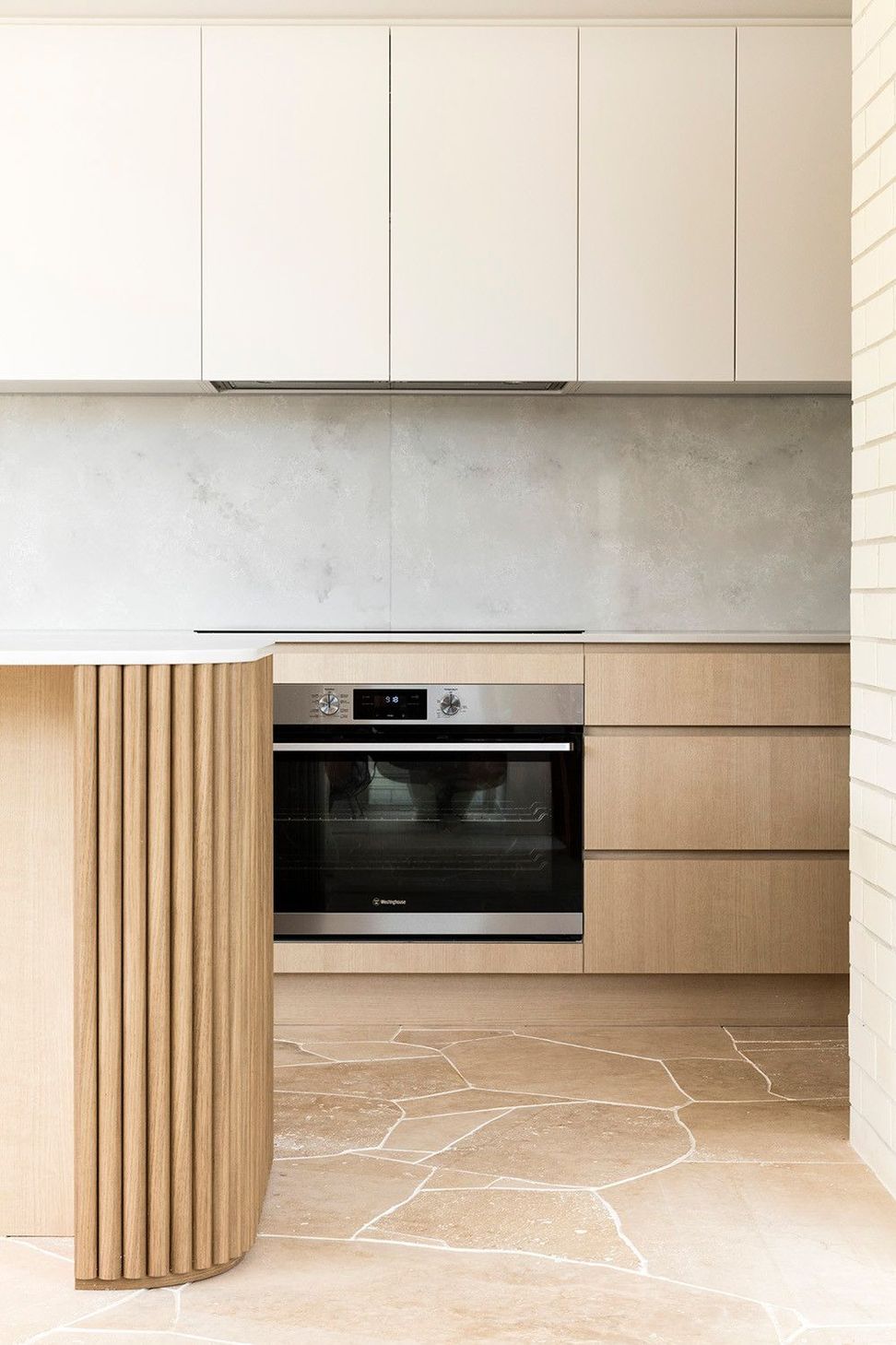 Viner Residence - Kitchen. Integrated oven within pale timber joinery.