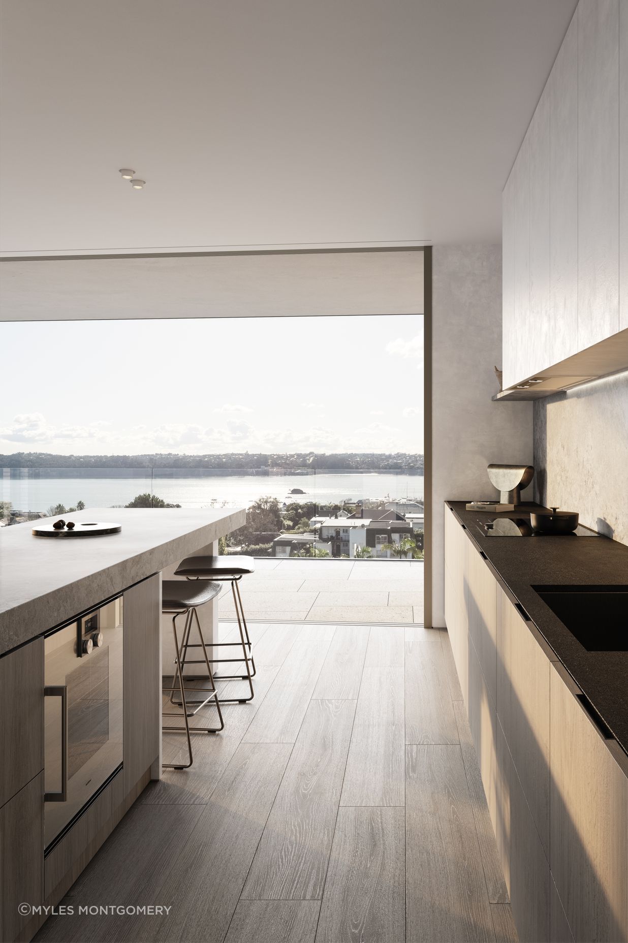 Kitchens are designed with custom-made cabinetry, state-of-the-art Gaggenau and Liebherr appliances, a honed marble island, and honed slate benchtops.