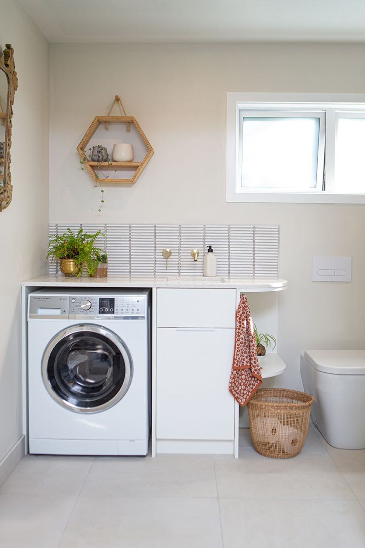 Design of the laundry was incorporated into the bathroom vanity unit.