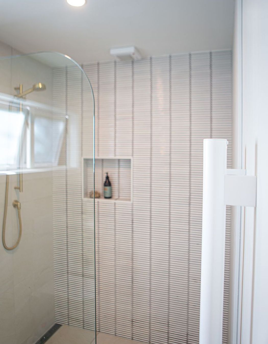'Grab' vertical heated towel rails in white.