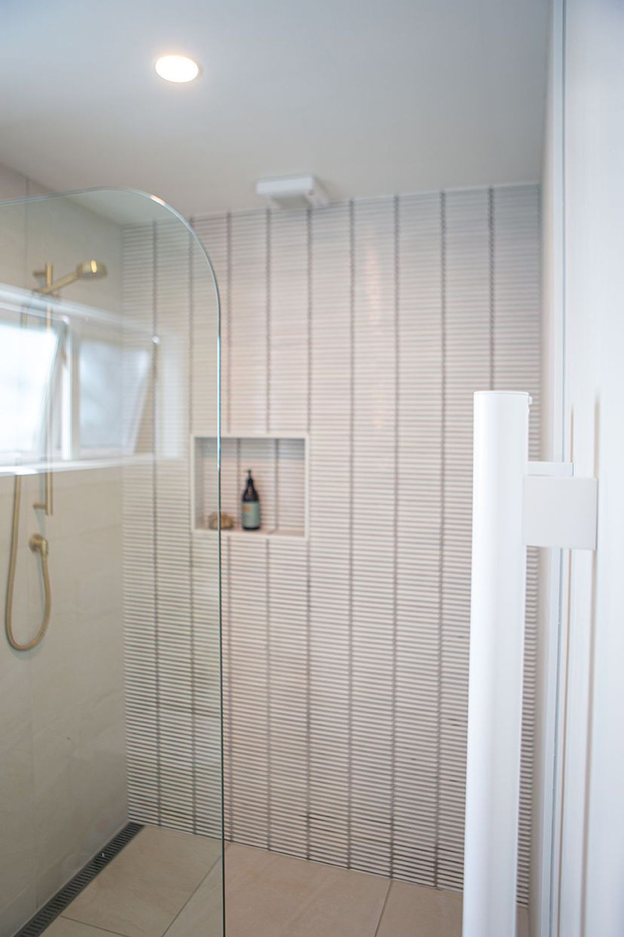 'Grab' vertical heated towel rails in white.