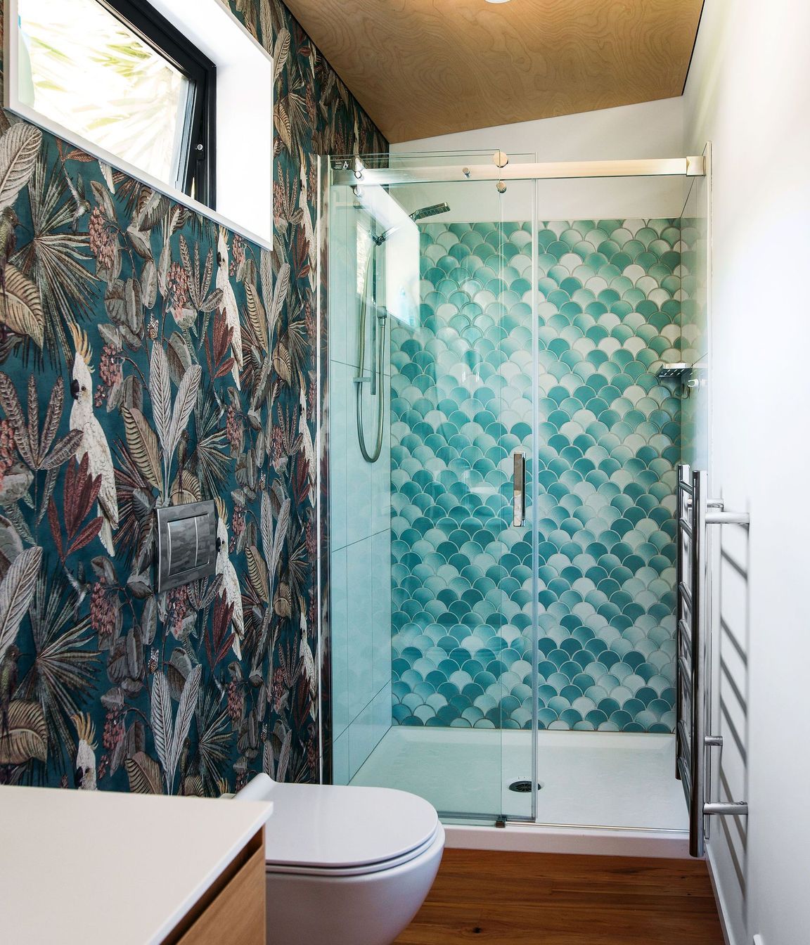 Tiled shower unit fits at the end of the space.