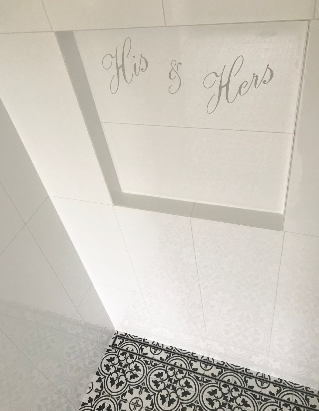 Shower niche with personalised design cut into tile & floor channel drain