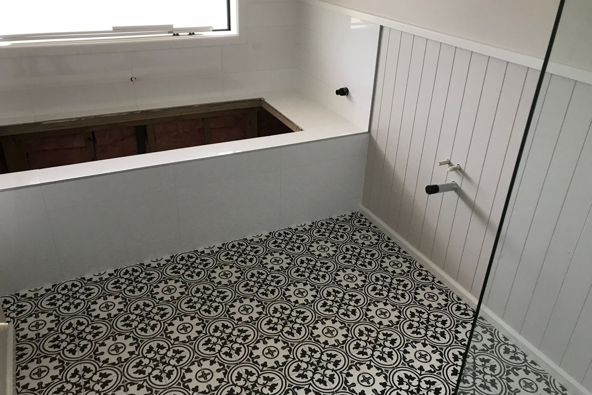 Tiled floor and bath cradle.