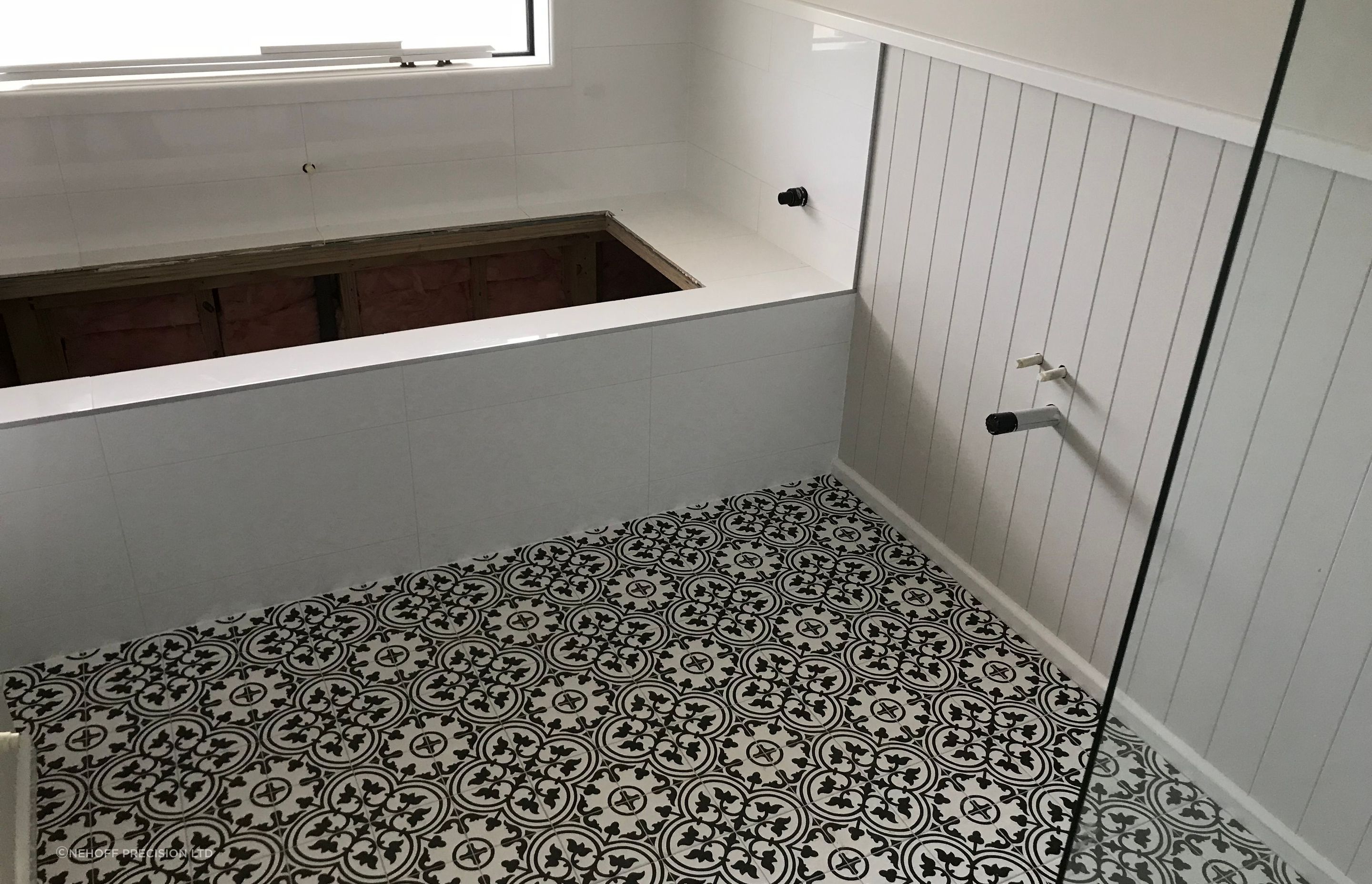 Tiled floor and bath cradle.