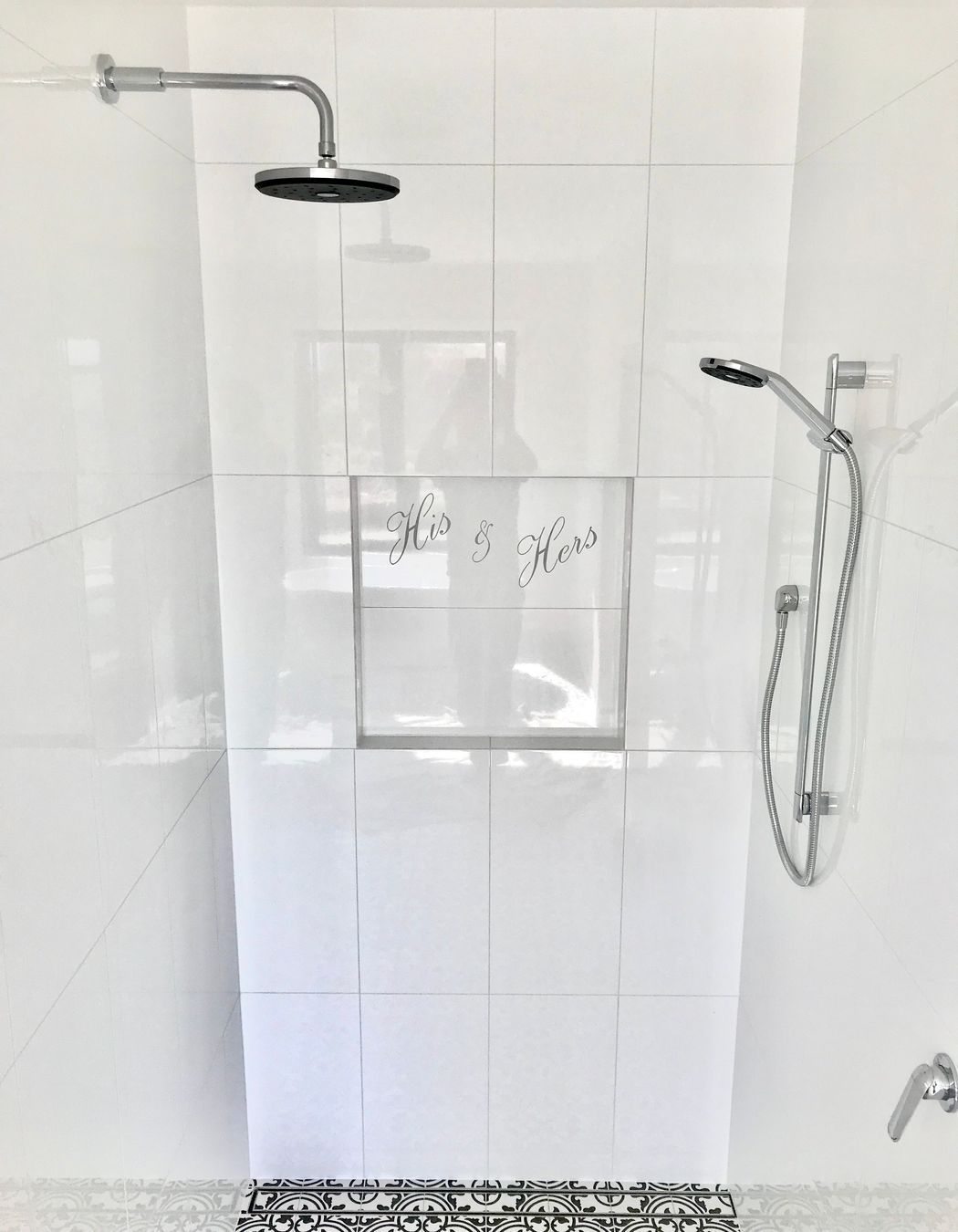 Tiled bathroom floor, shower walls & niche with personalised design cut into tile.