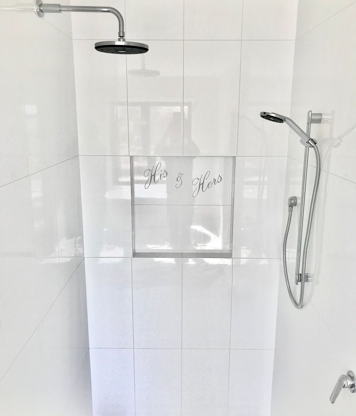 Tiled bathroom floor, shower walls &amp; niche with personalised design cut into tile.
