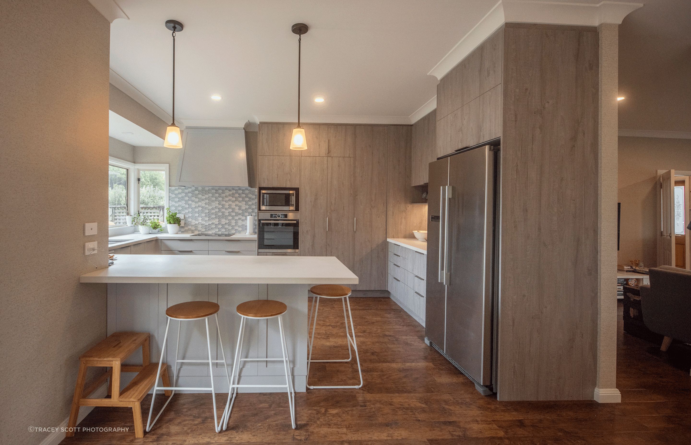 Multiple colours and textures in the cabinetry and splashback make this space interesting