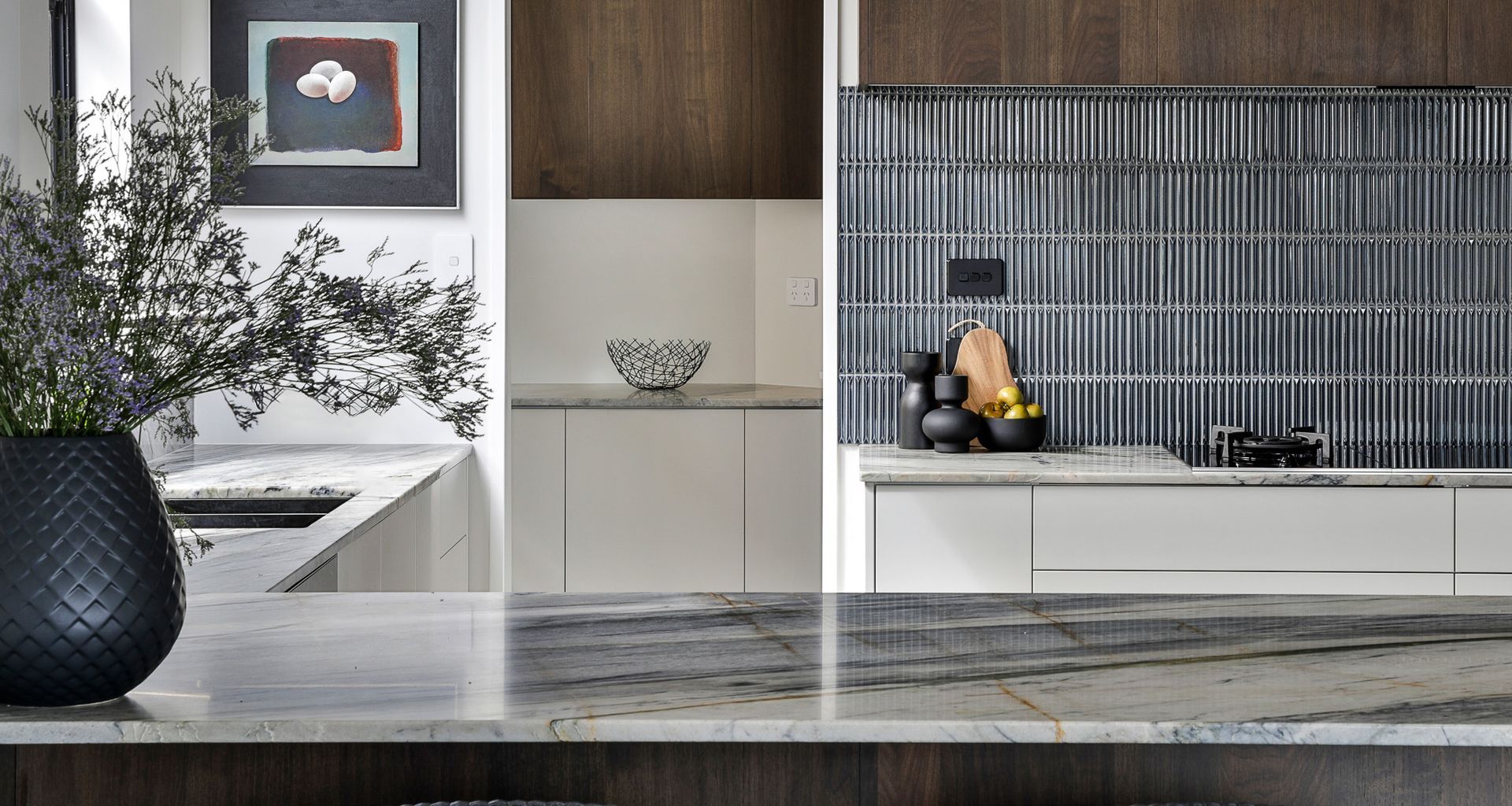 Beautiful warm brown wood tones, with the natural stone as the hero in here and the blue tiles to bring the scheme together