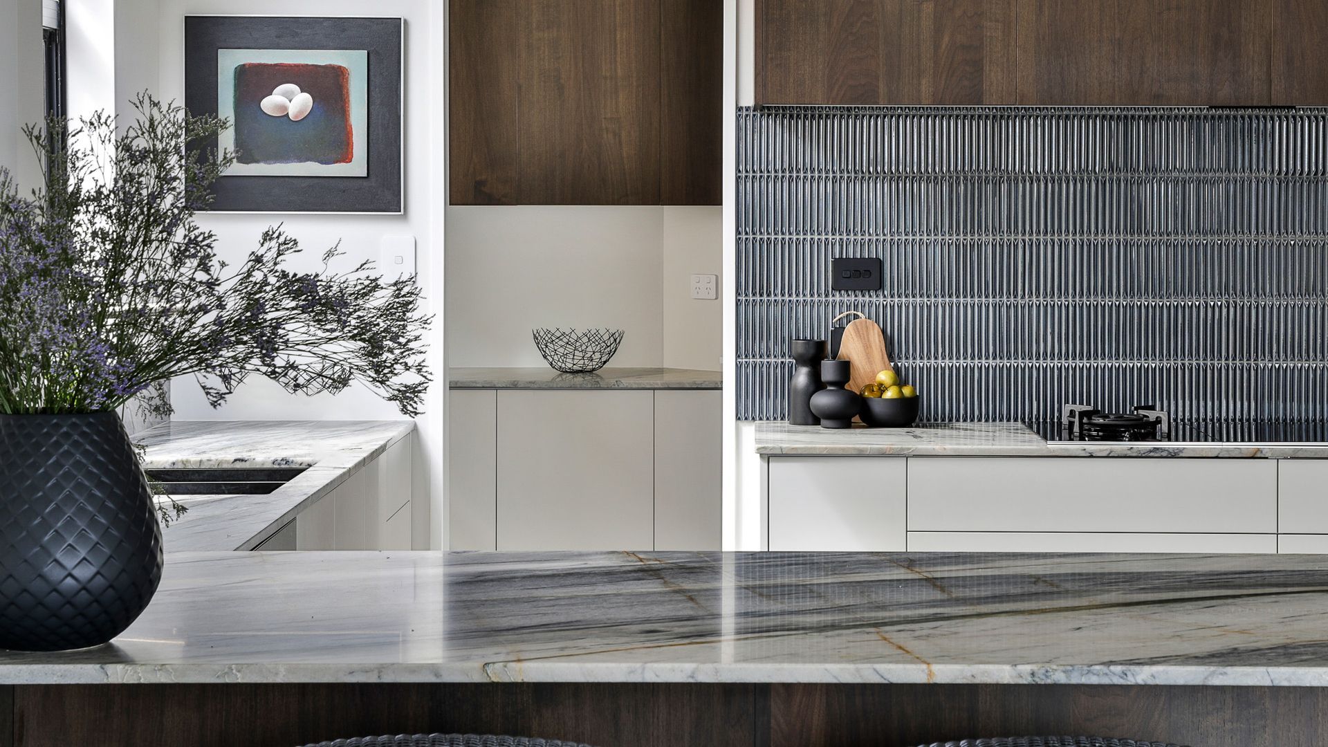 Beautiful warm brown wood tones, with the natural stone as the hero in here and the blue tiles to bring the scheme together