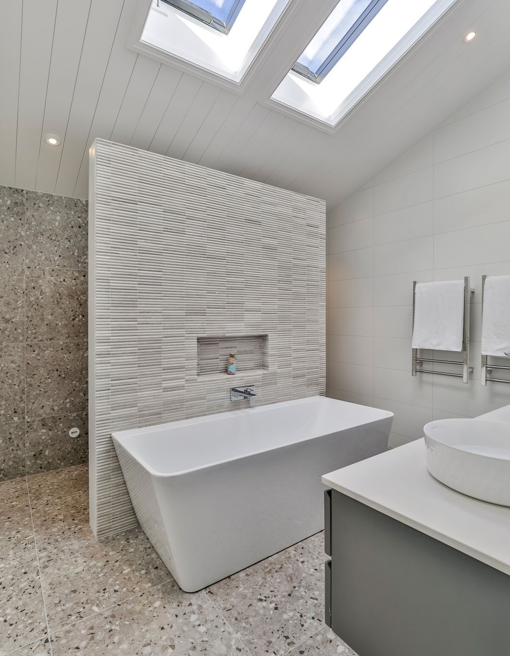 TILE DEPOT / Tiles: Colosseum Travertine 305x305mm, Blanco Brillo Matt 300x600mm, Frammenta Taupe 597x597mm / Heated Towel Rails: Heirloom Forme