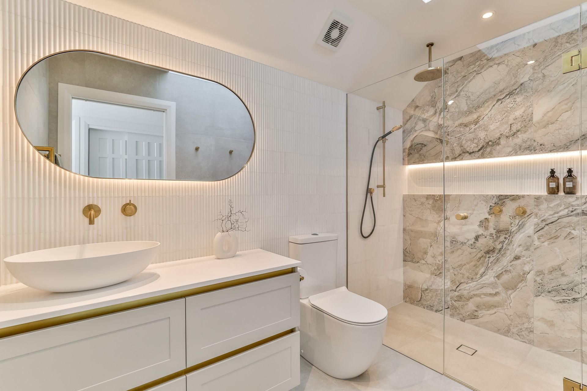 Colosseum Crystal White Mosaic with Abstract White 600x600mm on the floors and the beautiful marble-effect Charme Illusion 598x1197mm on the shower wall.