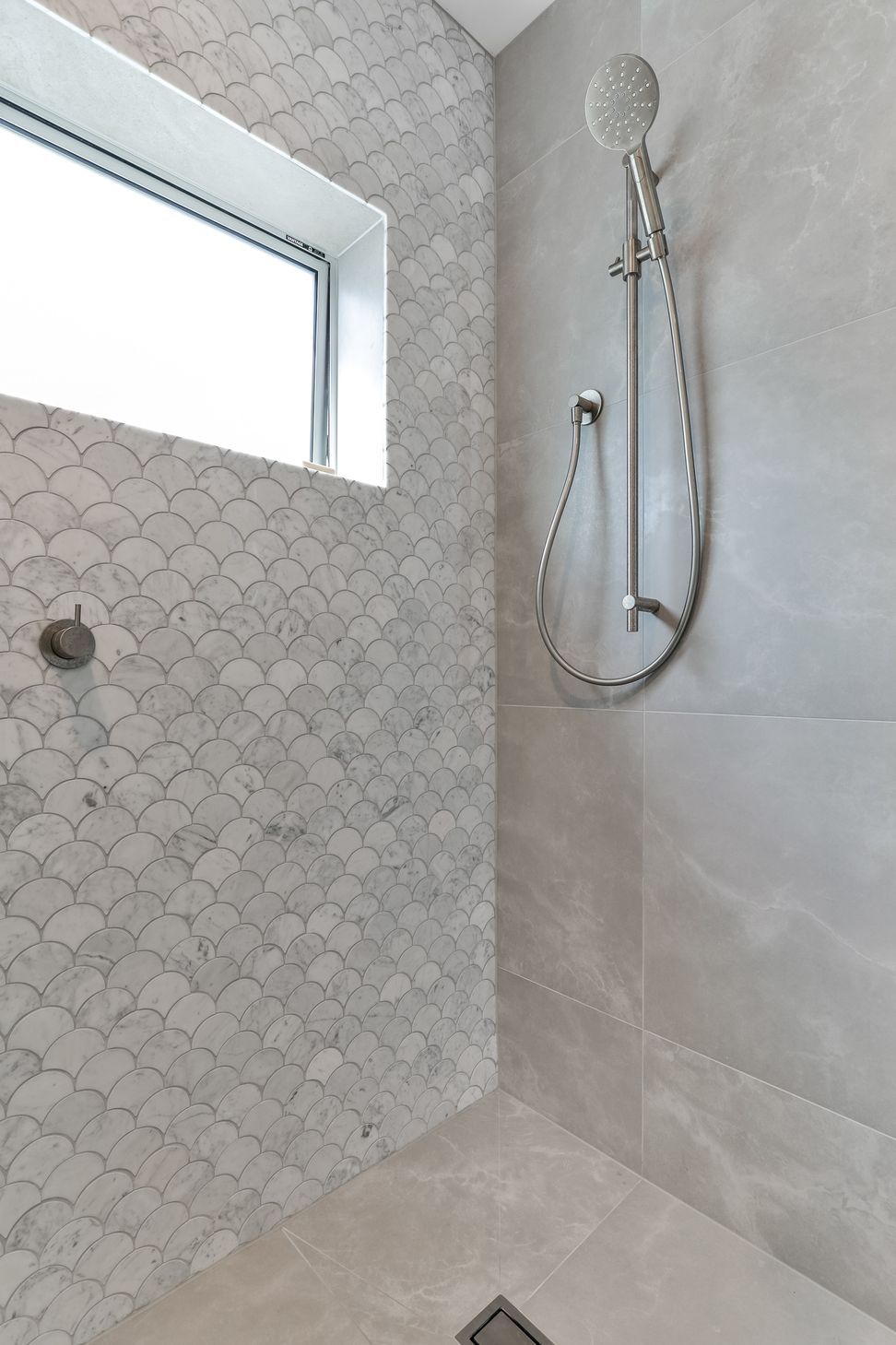 Tiles used: Stardust Moon 597x597mm floor and wall,Fish Scale Carrara Honed Mosaic 245x265mm