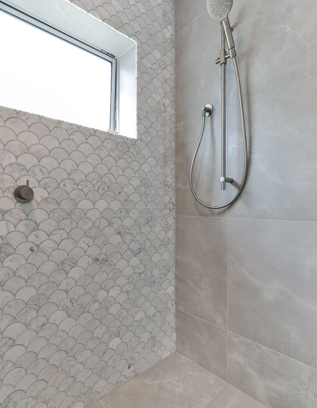 Tiles used: Stardust Moon 597x597mm floor and wall,Fish Scale Carrara Honed Mosaic 245x265mm