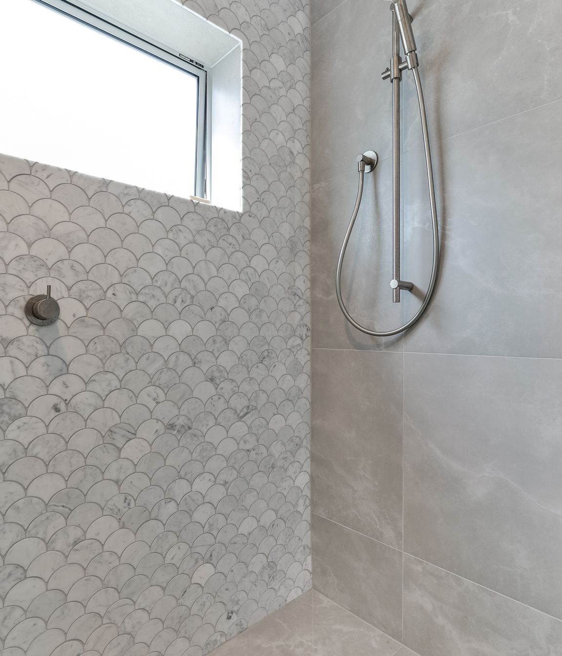 Tiles used: Stardust Moon 597x597mm floor and wall,Fish Scale Carrara Honed Mosaic 245x265mm