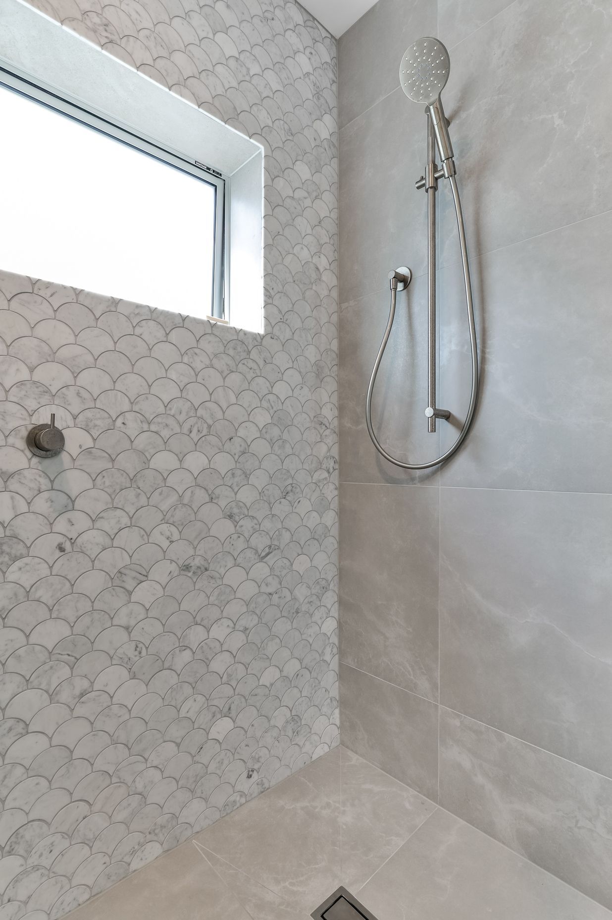 Tiles used: Stardust Moon 597x597mm floor and wall,Fish Scale Carrara Honed Mosaic 245x265mm