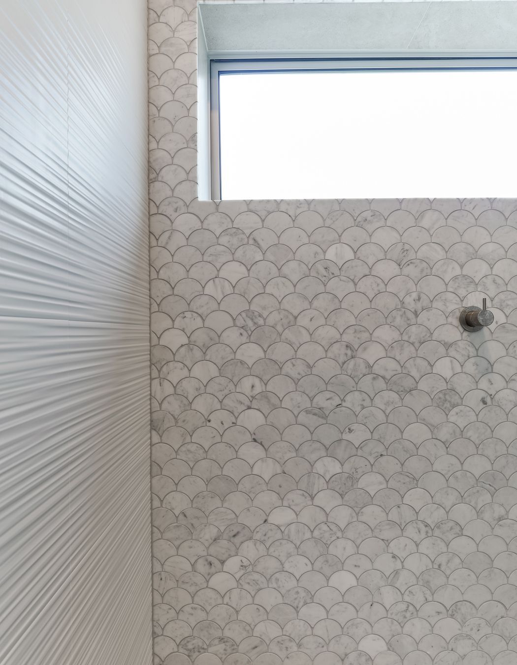 Tiles used: Stardust Moon 597x597mm floor and wall, 4D Linear white (not stocked, indent only), Fish Scale Carrara Honed Mosaic 245x265mm