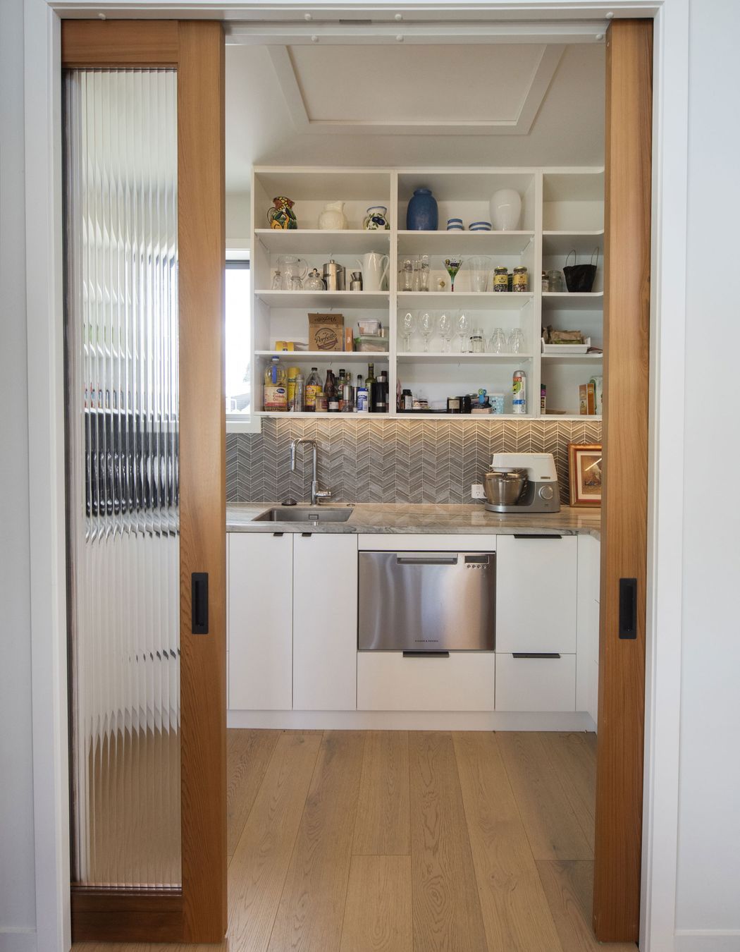 Reeded glass doors into walk in pantry