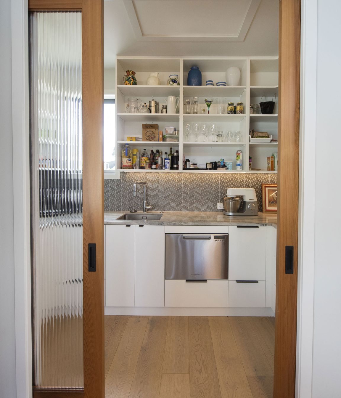 Reeded glass doors into walk in pantry