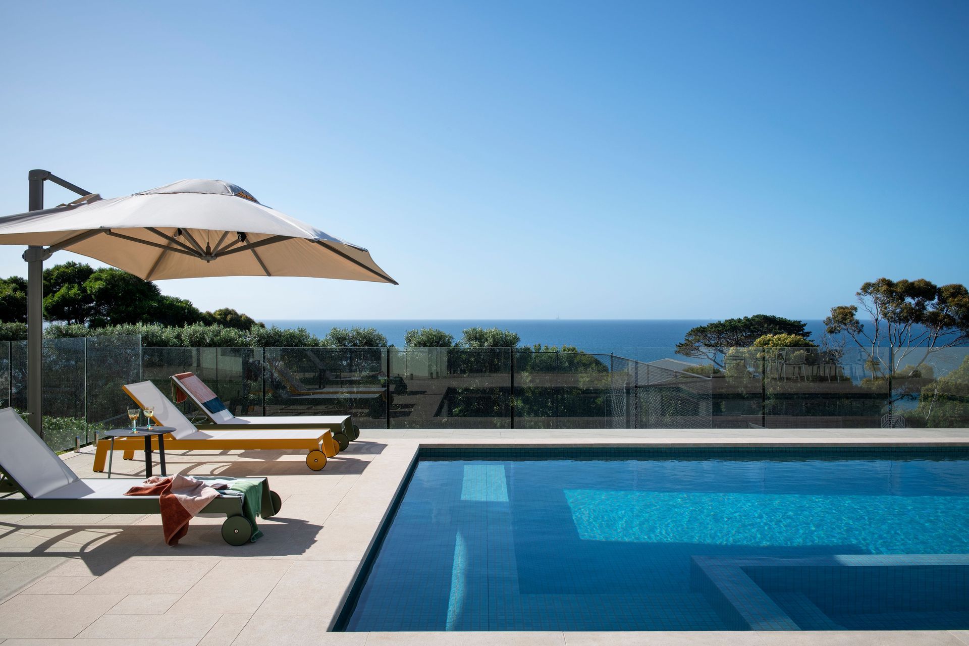 The pool was designed to mimic the water view and sandy shores.