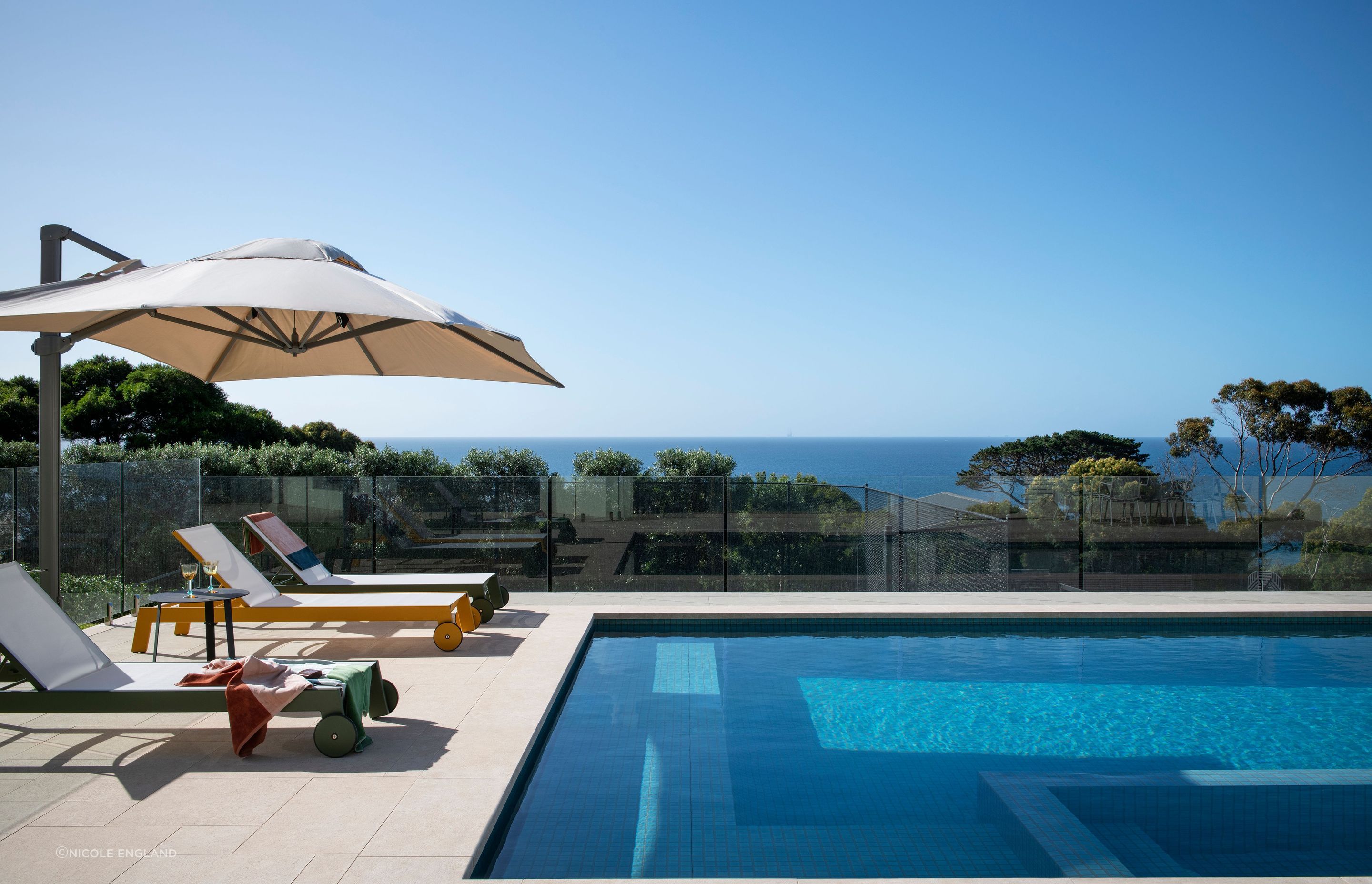 The pool was designed to mimic the water view and sandy shores.